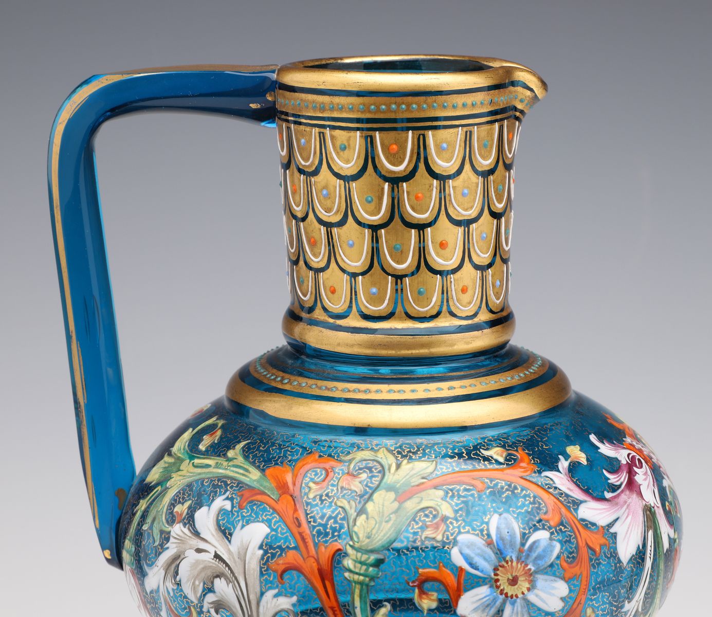 A MOSER BLUE GLASS JUG WITH GILT AND ENAMEL DECORATION