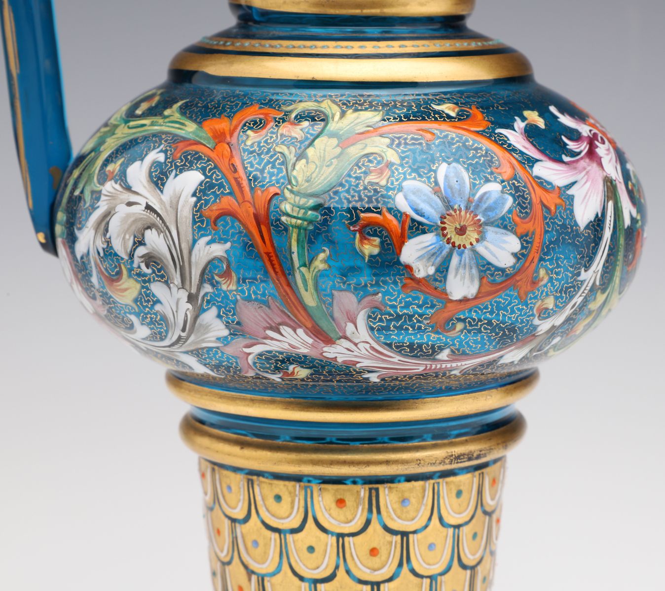 A MOSER BLUE GLASS JUG WITH GILT AND ENAMEL DECORATION