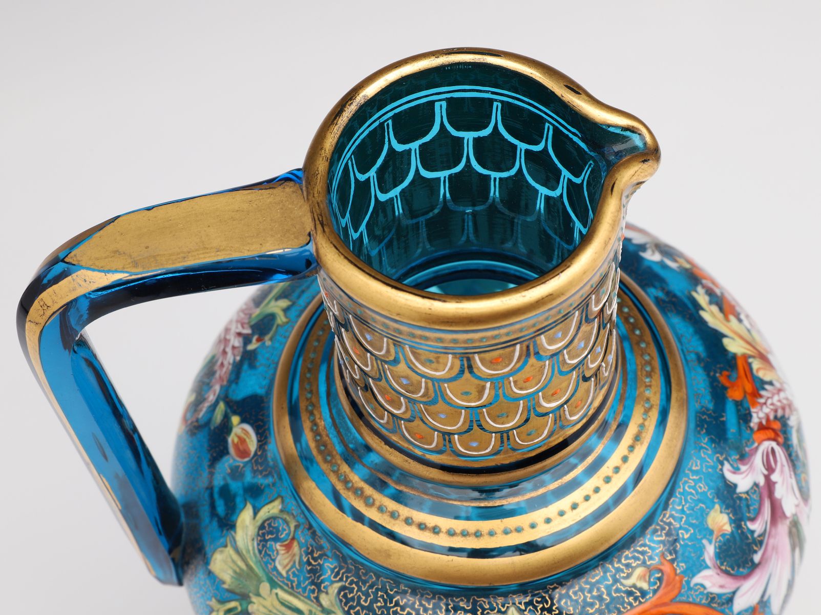 A MOSER BLUE GLASS JUG WITH GILT AND ENAMEL DECORATION