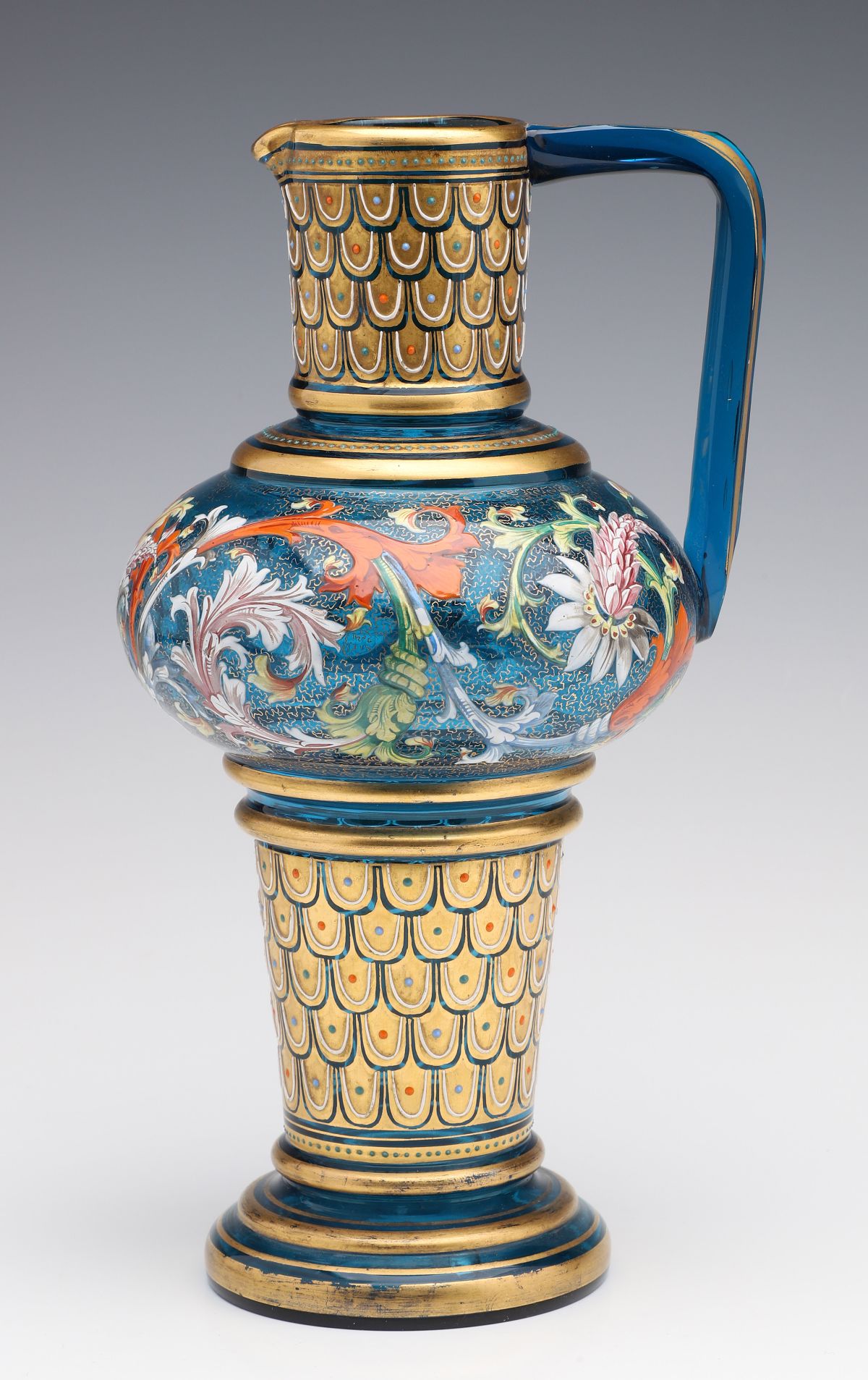 A MOSER BLUE GLASS JUG WITH GILT AND ENAMEL DECORATION