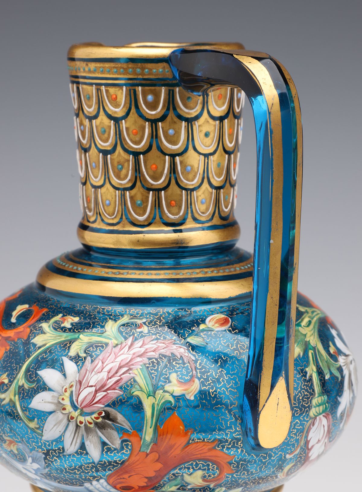 A MOSER BLUE GLASS JUG WITH GILT AND ENAMEL DECORATION