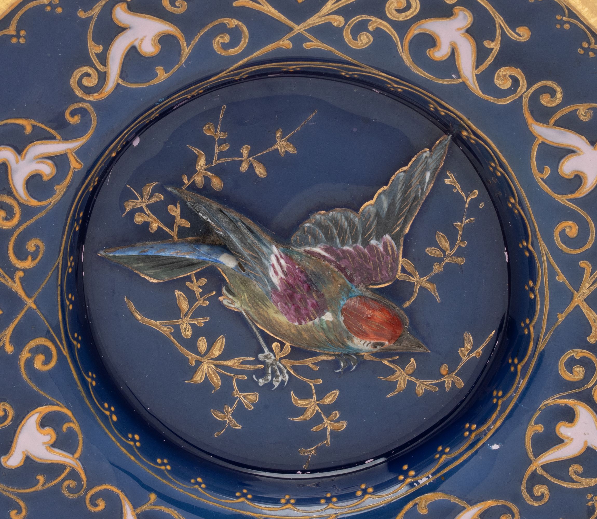 A RARE MOSER PLATE WITH SCULPTED BIRD IN HIGH RELIEF