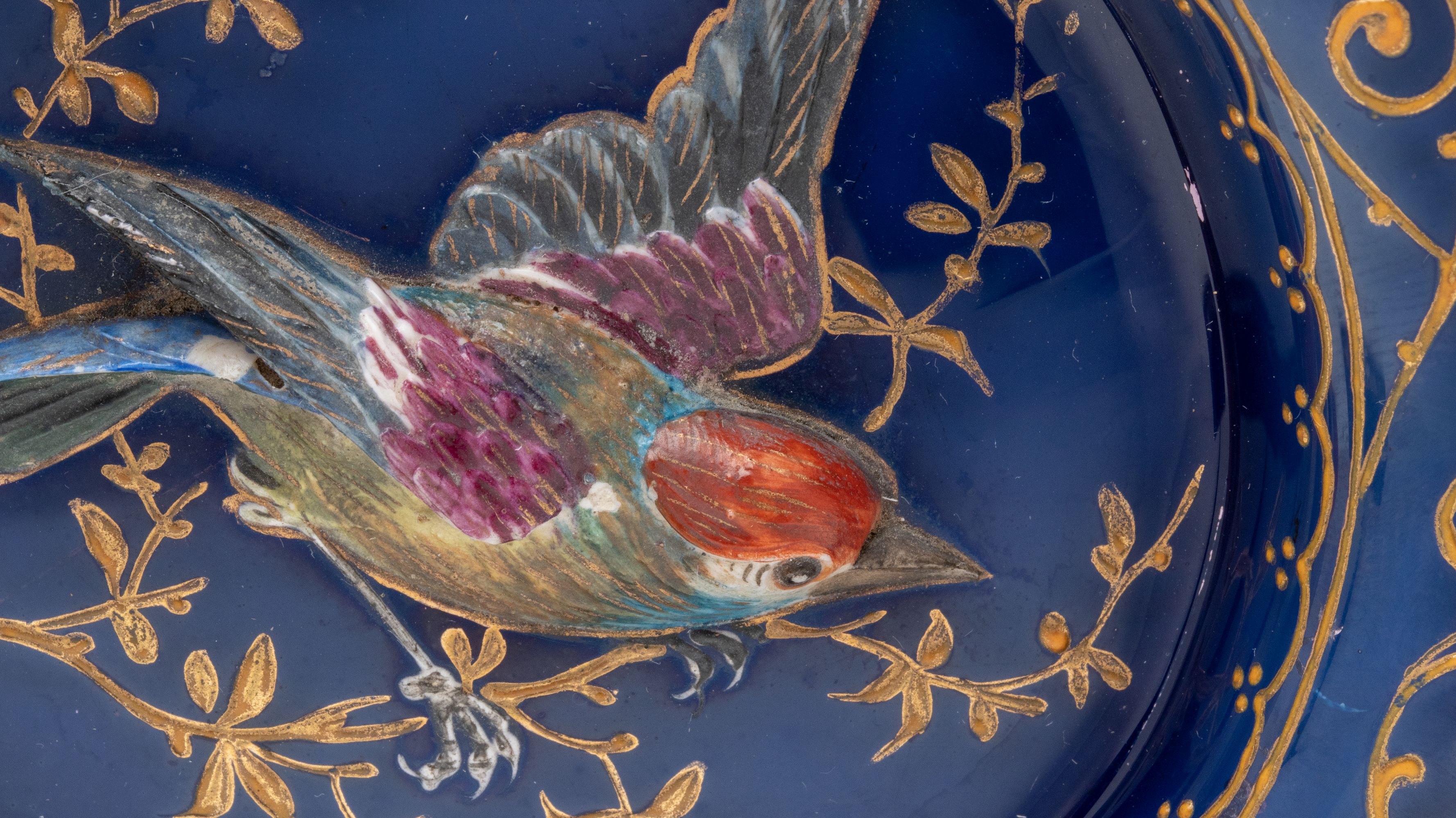 A RARE MOSER PLATE WITH SCULPTED BIRD IN HIGH RELIEF