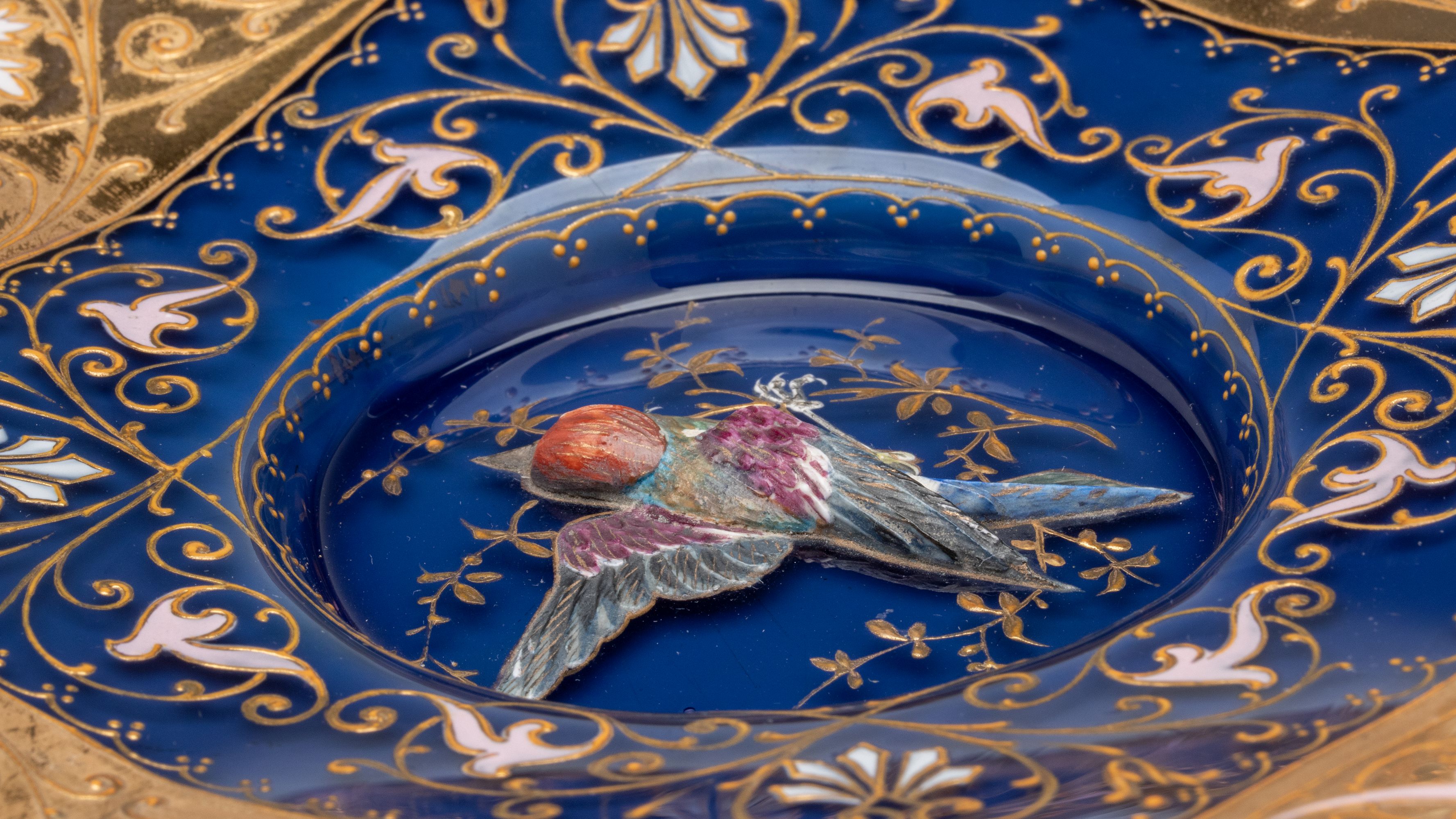 A RARE MOSER PLATE WITH SCULPTED BIRD IN HIGH RELIEF