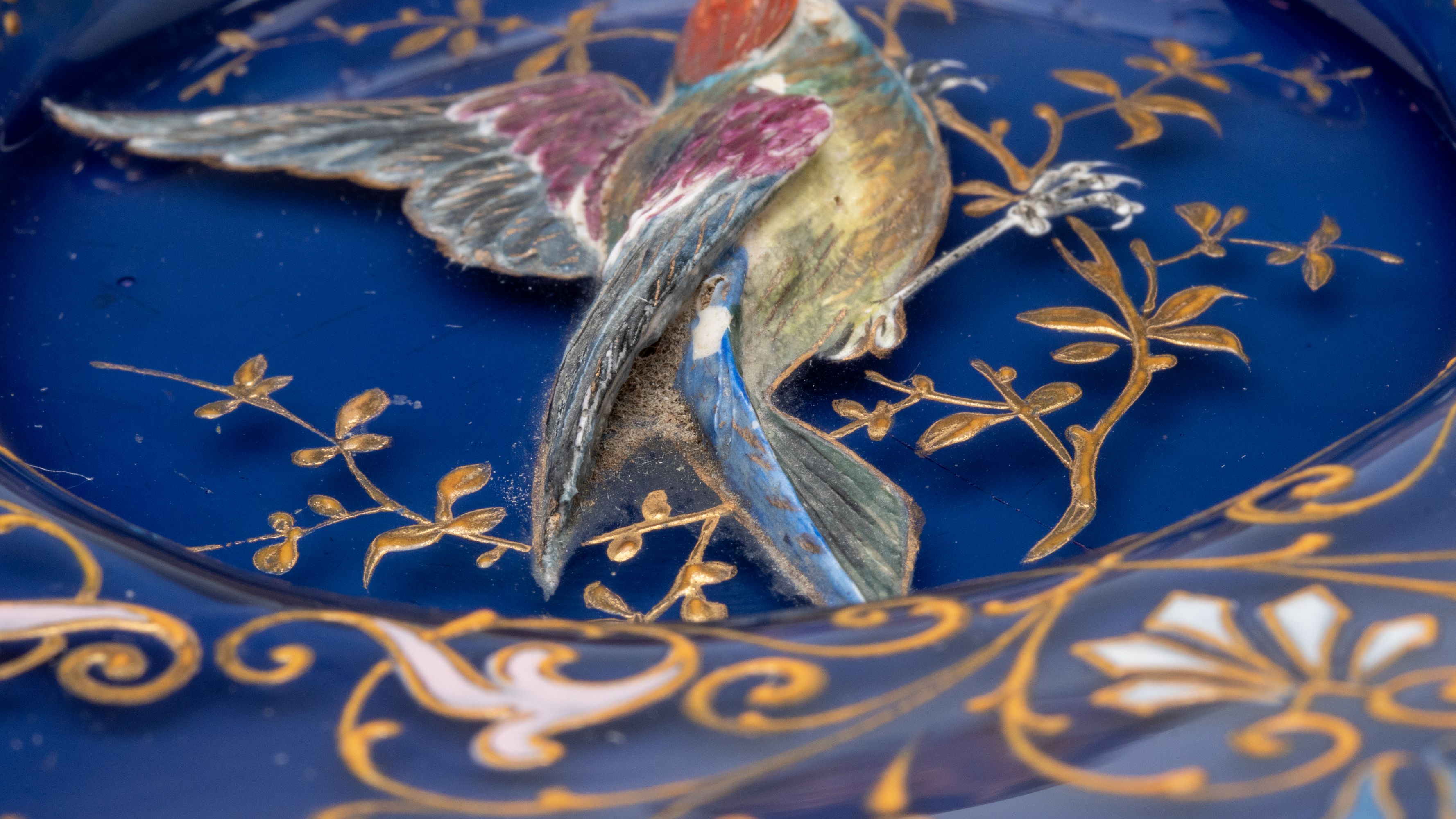 A RARE MOSER PLATE WITH SCULPTED BIRD IN HIGH RELIEF