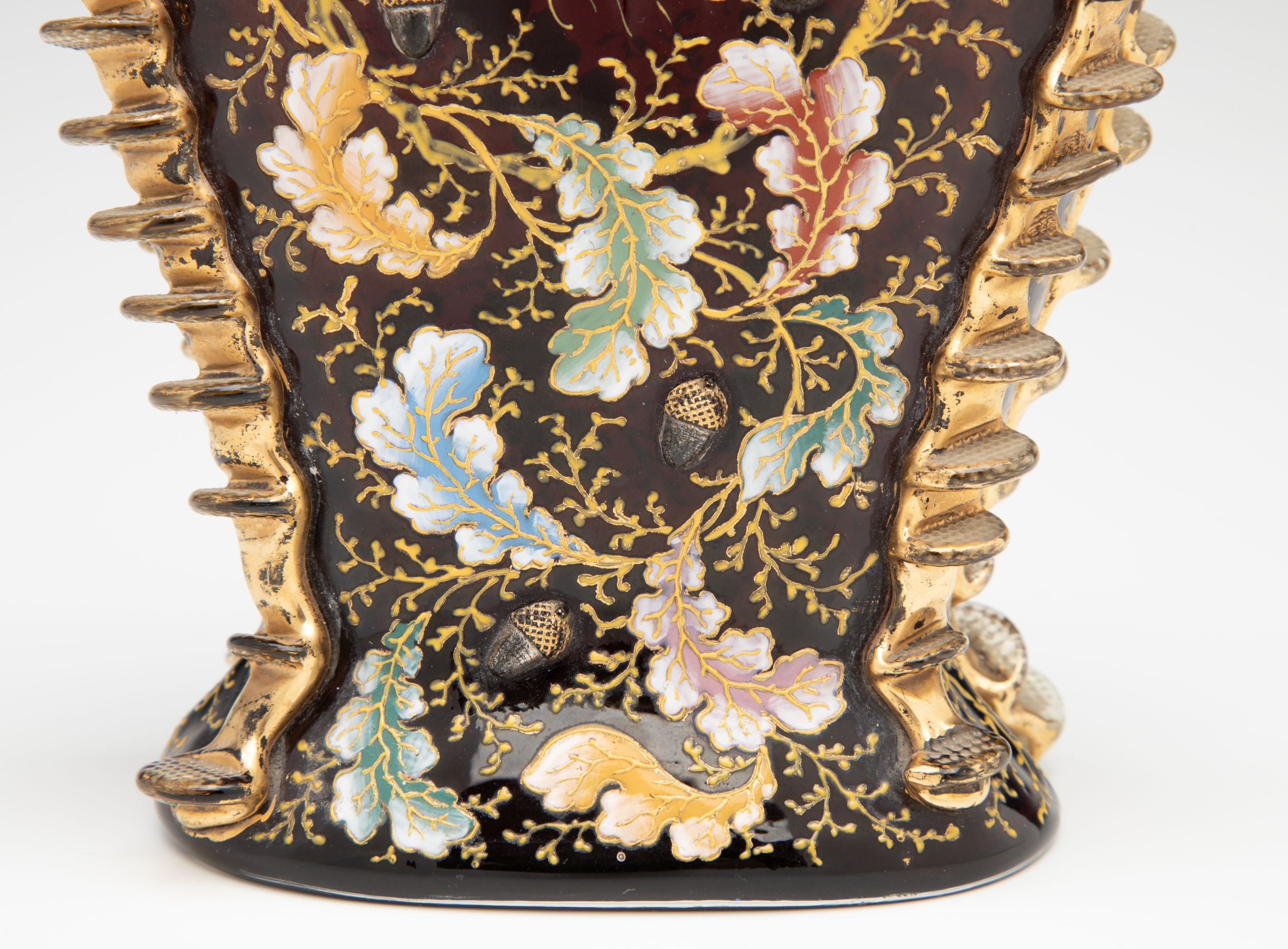 A MOSER DARK RUBY CABINET VASE WITH ACORNS AND RIGAREE