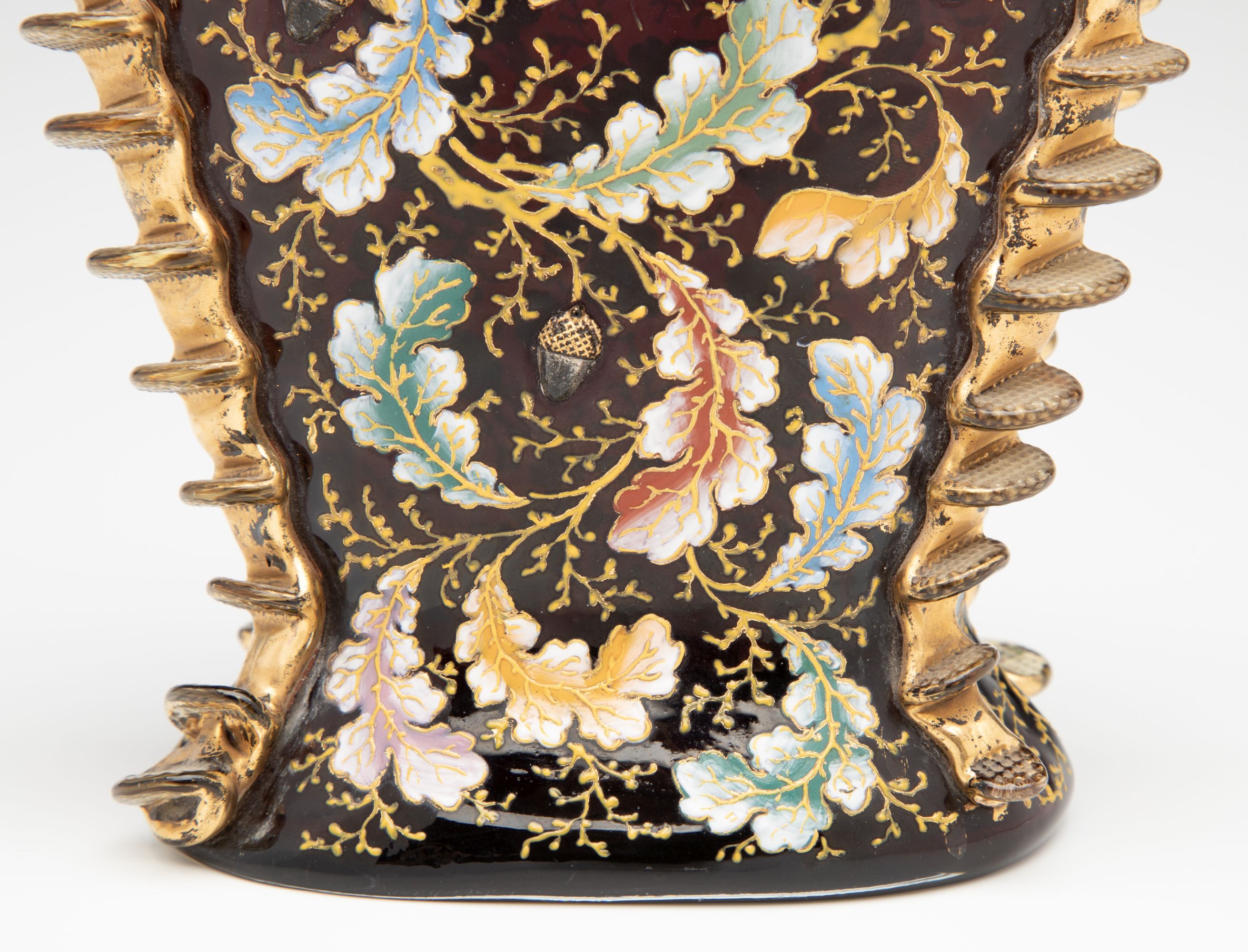 A MOSER DARK RUBY CABINET VASE WITH ACORNS AND RIGAREE