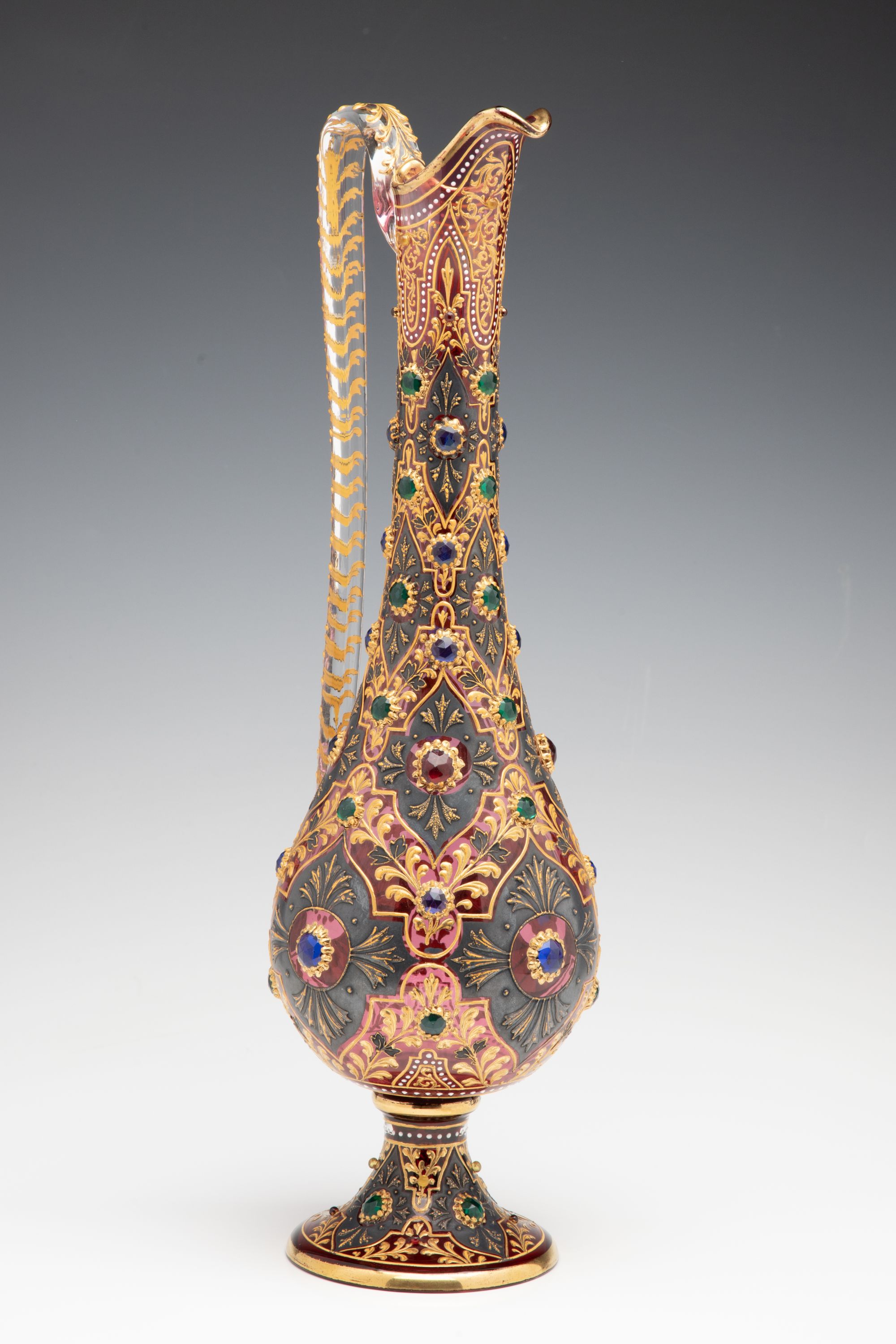 A JEWELED MOSER CRANBERRY EWER WITH MUGHAL DESIGNS