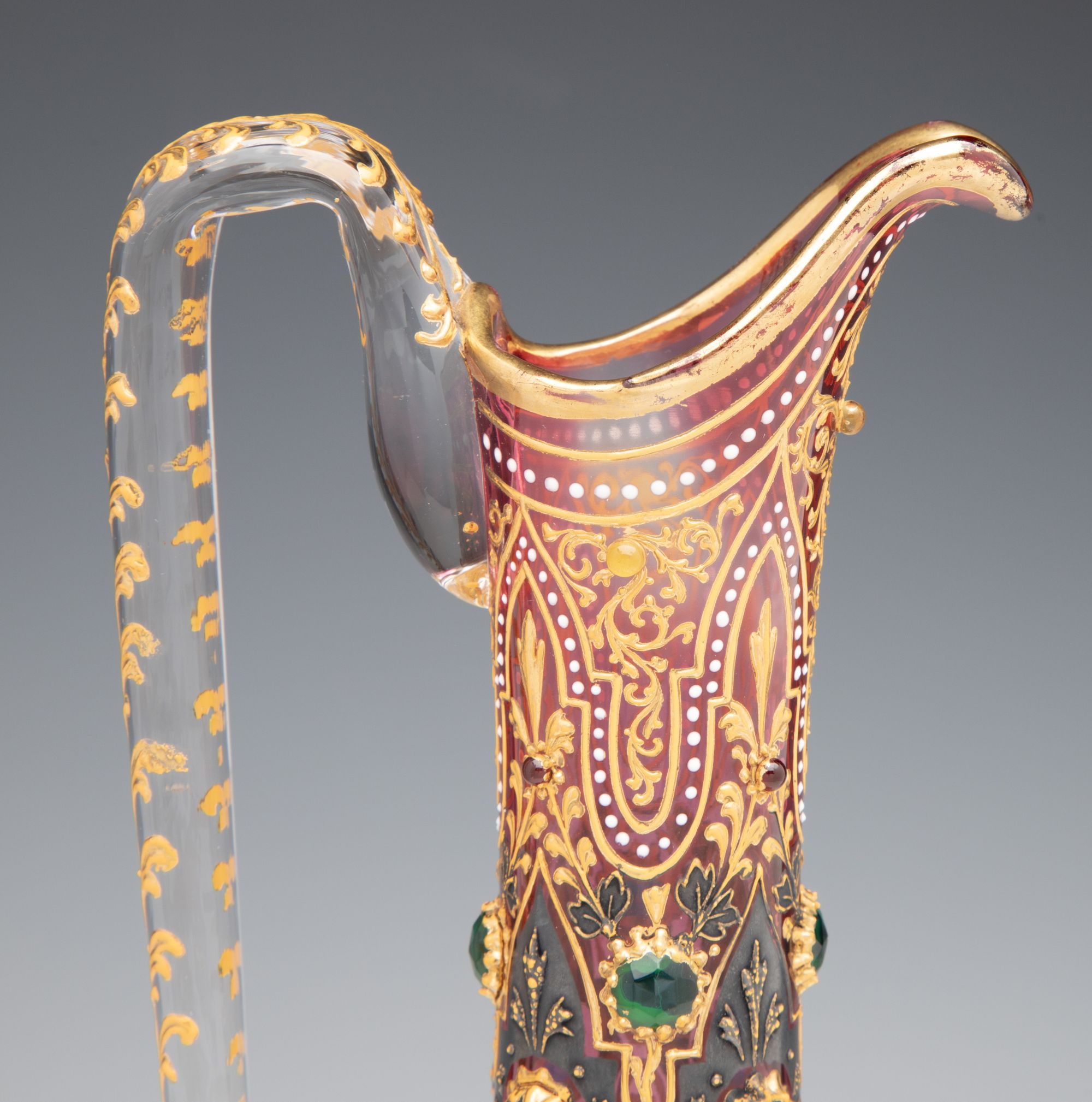 A JEWELED MOSER CRANBERRY EWER WITH MUGHAL DESIGNS