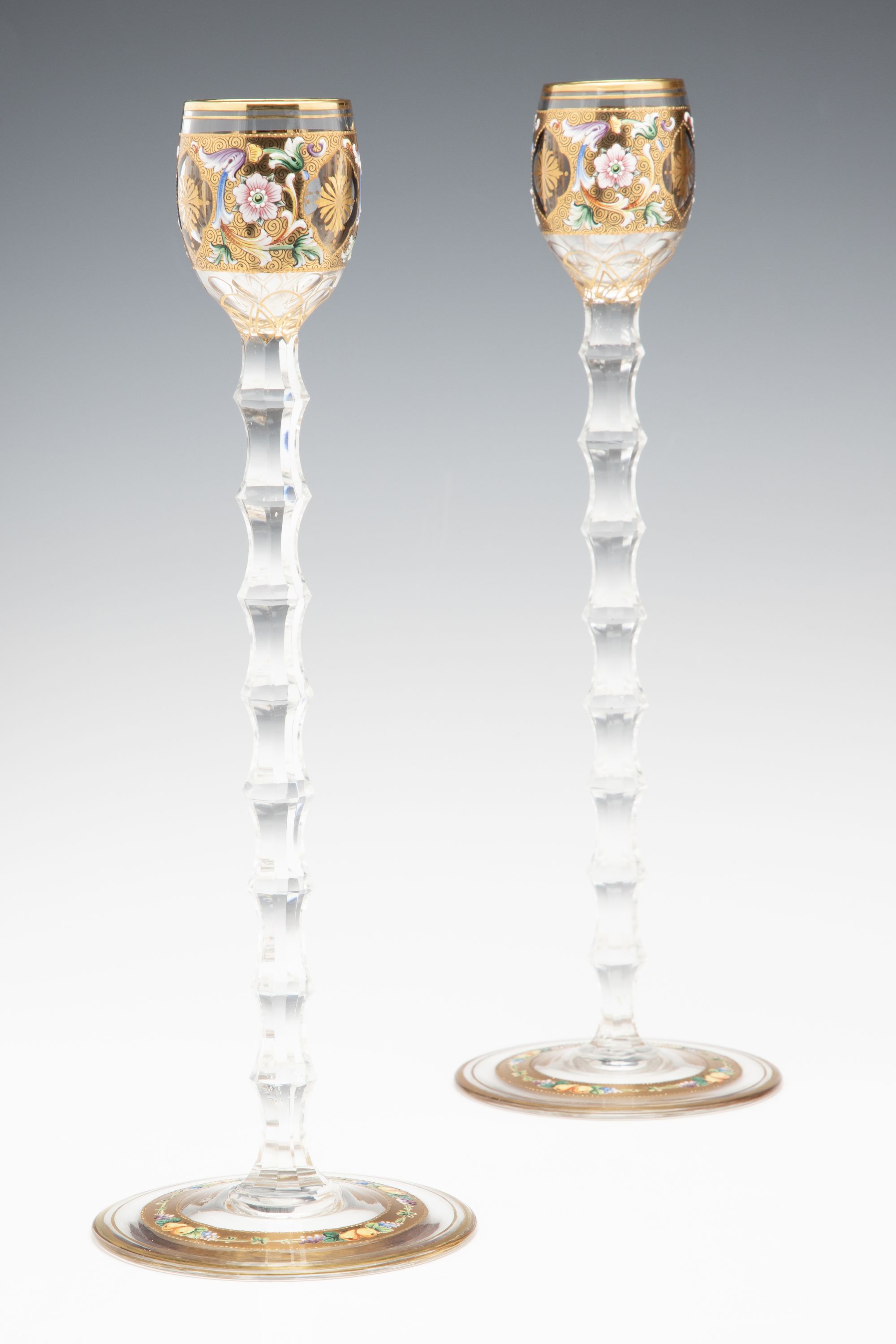 TWO MOSER GILT AND ENAMEL CORDIALS ON TALL CUT STEMS