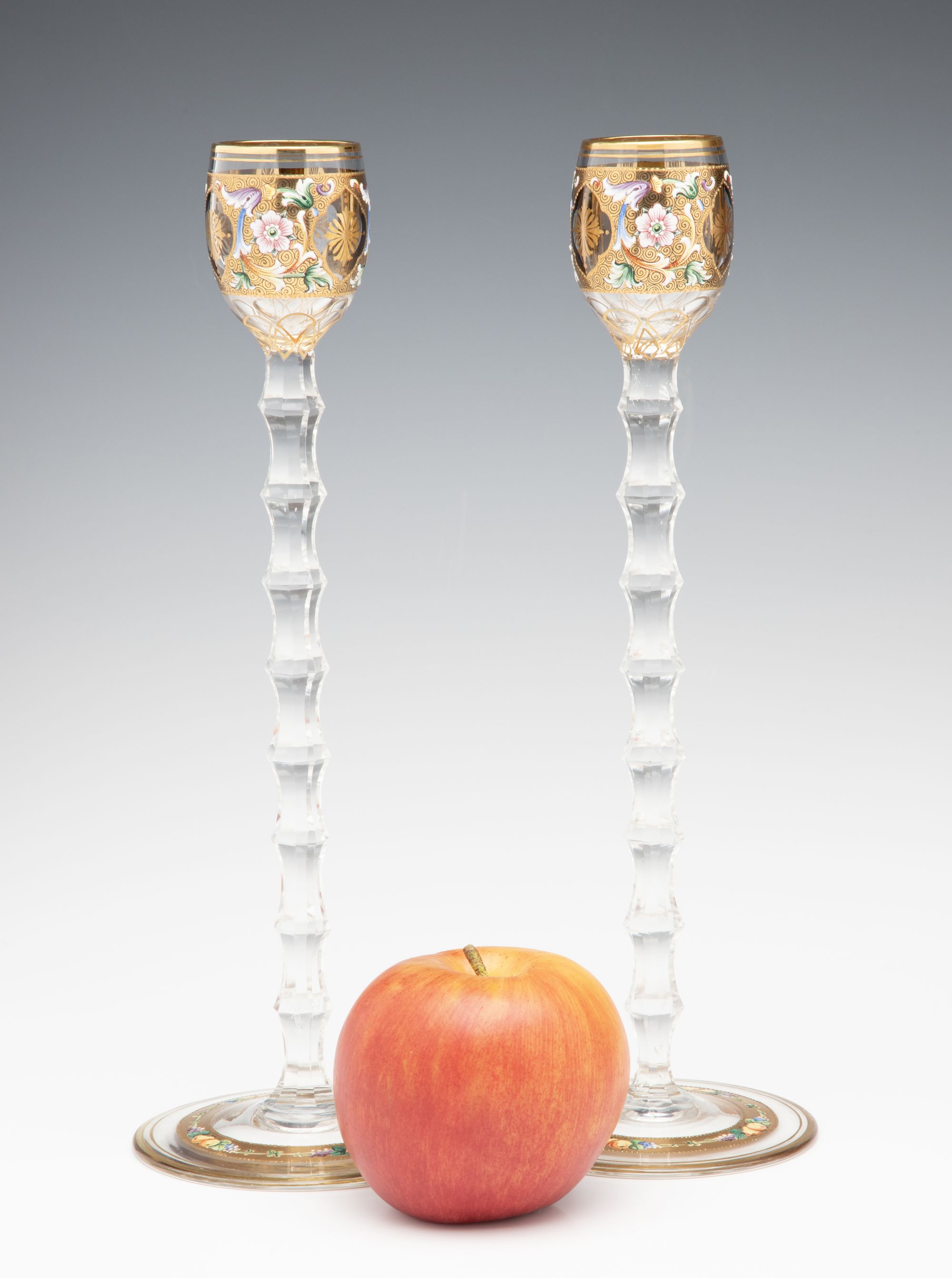 TWO MOSER GILT AND ENAMEL CORDIALS ON TALL CUT STEMS