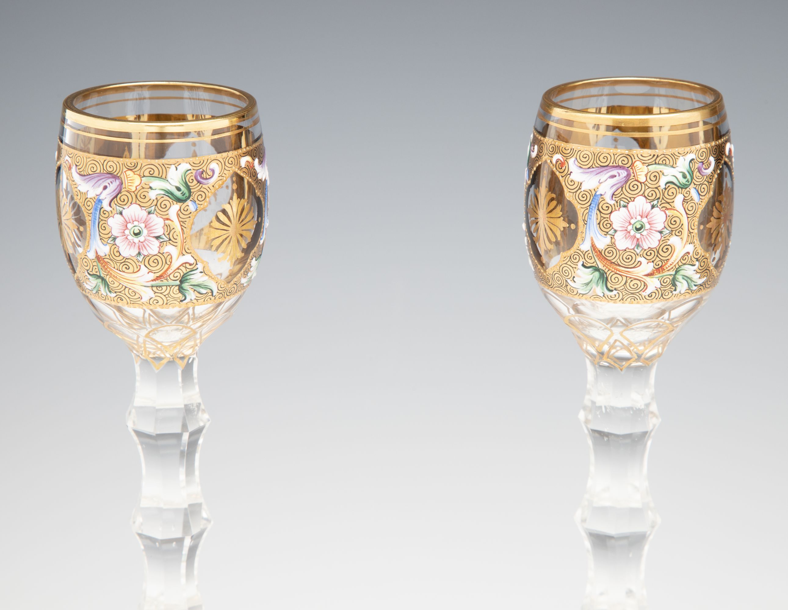 TWO MOSER GILT AND ENAMEL CORDIALS ON TALL CUT STEMS