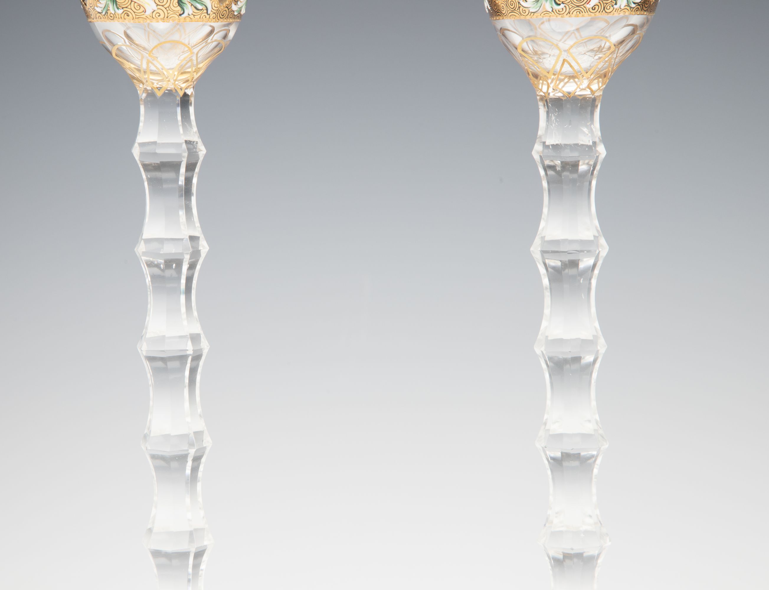 TWO MOSER GILT AND ENAMEL CORDIALS ON TALL CUT STEMS