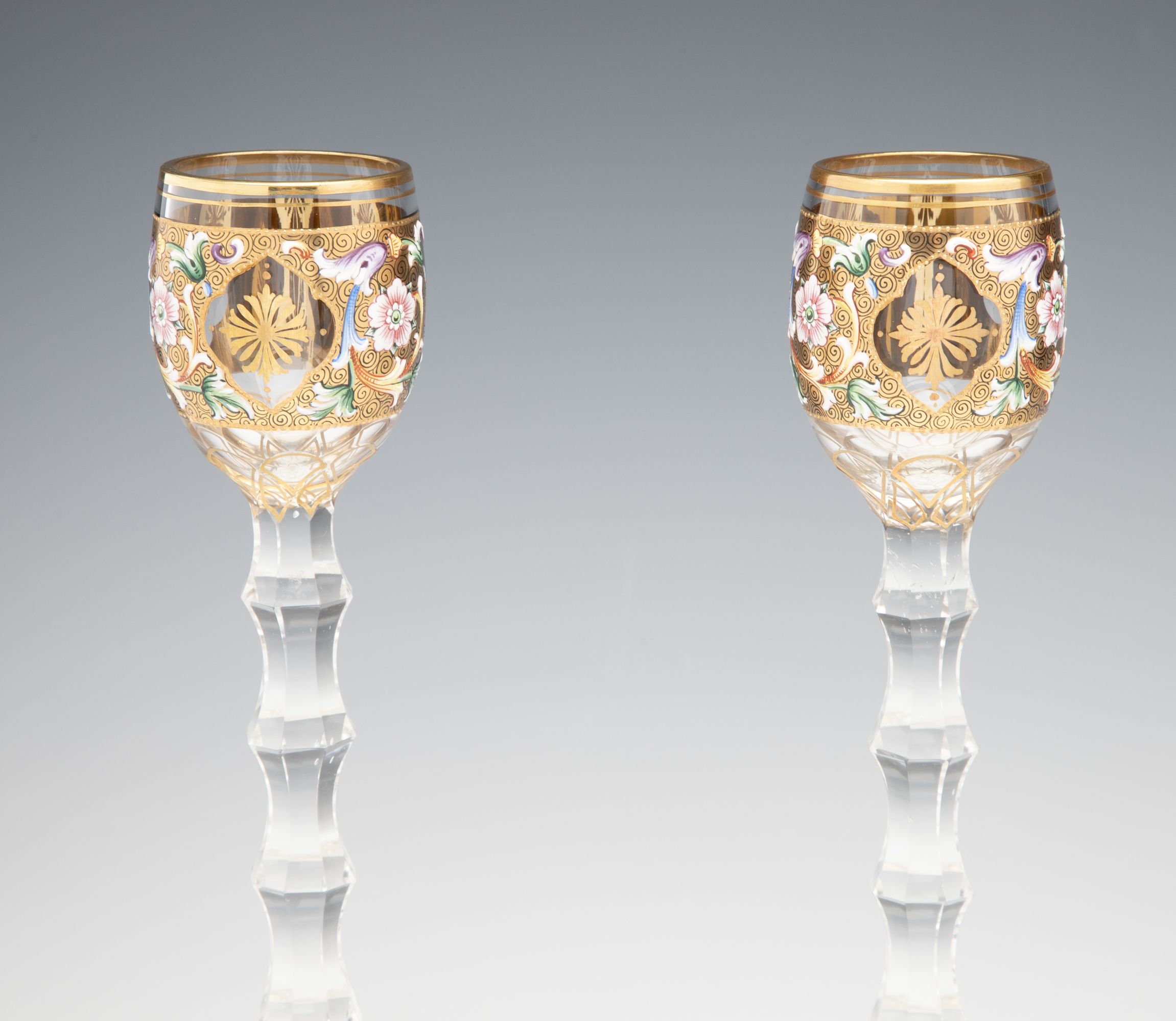 TWO MOSER GILT AND ENAMEL CORDIALS ON TALL CUT STEMS