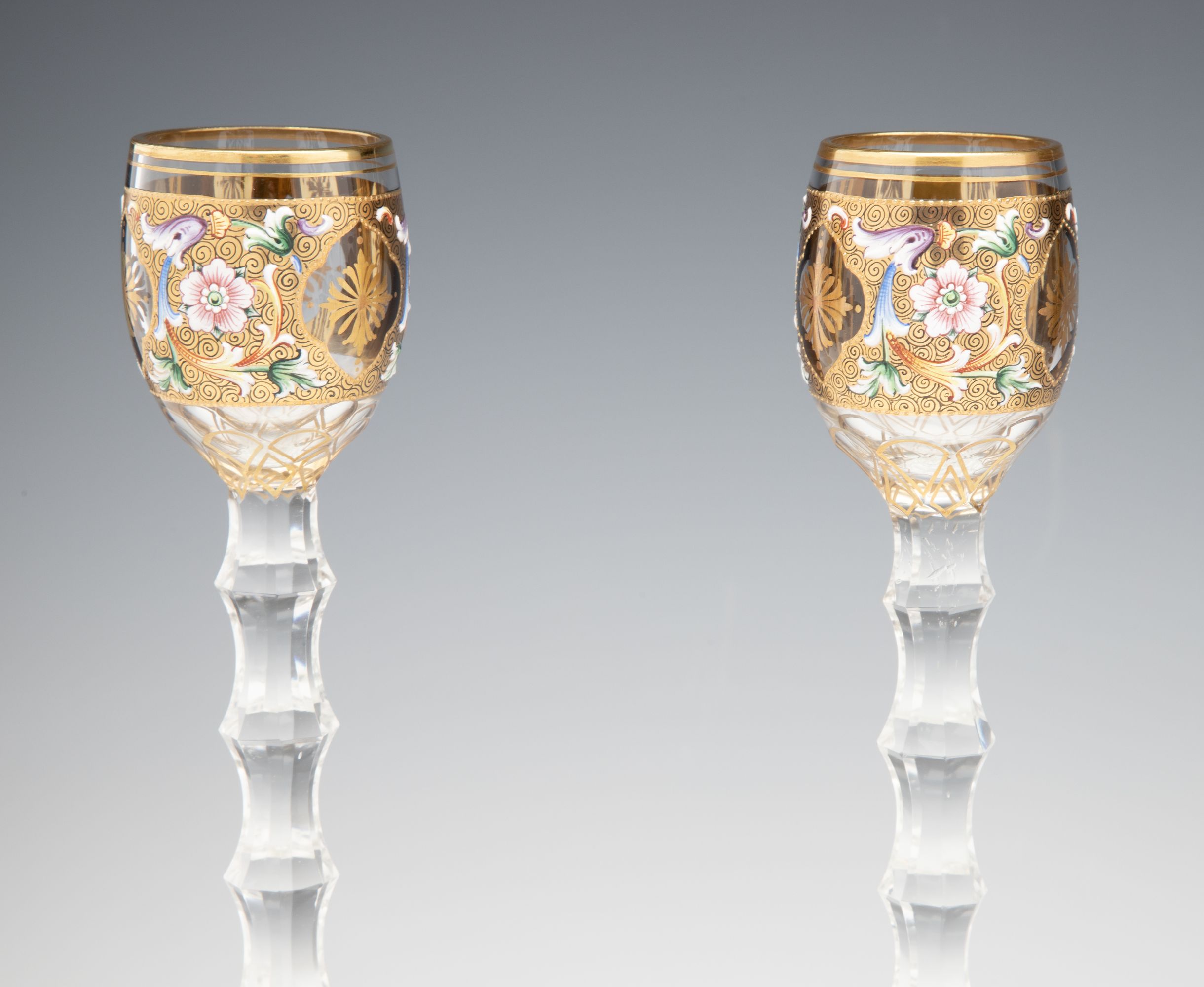 TWO MOSER GILT AND ENAMEL CORDIALS ON TALL CUT STEMS