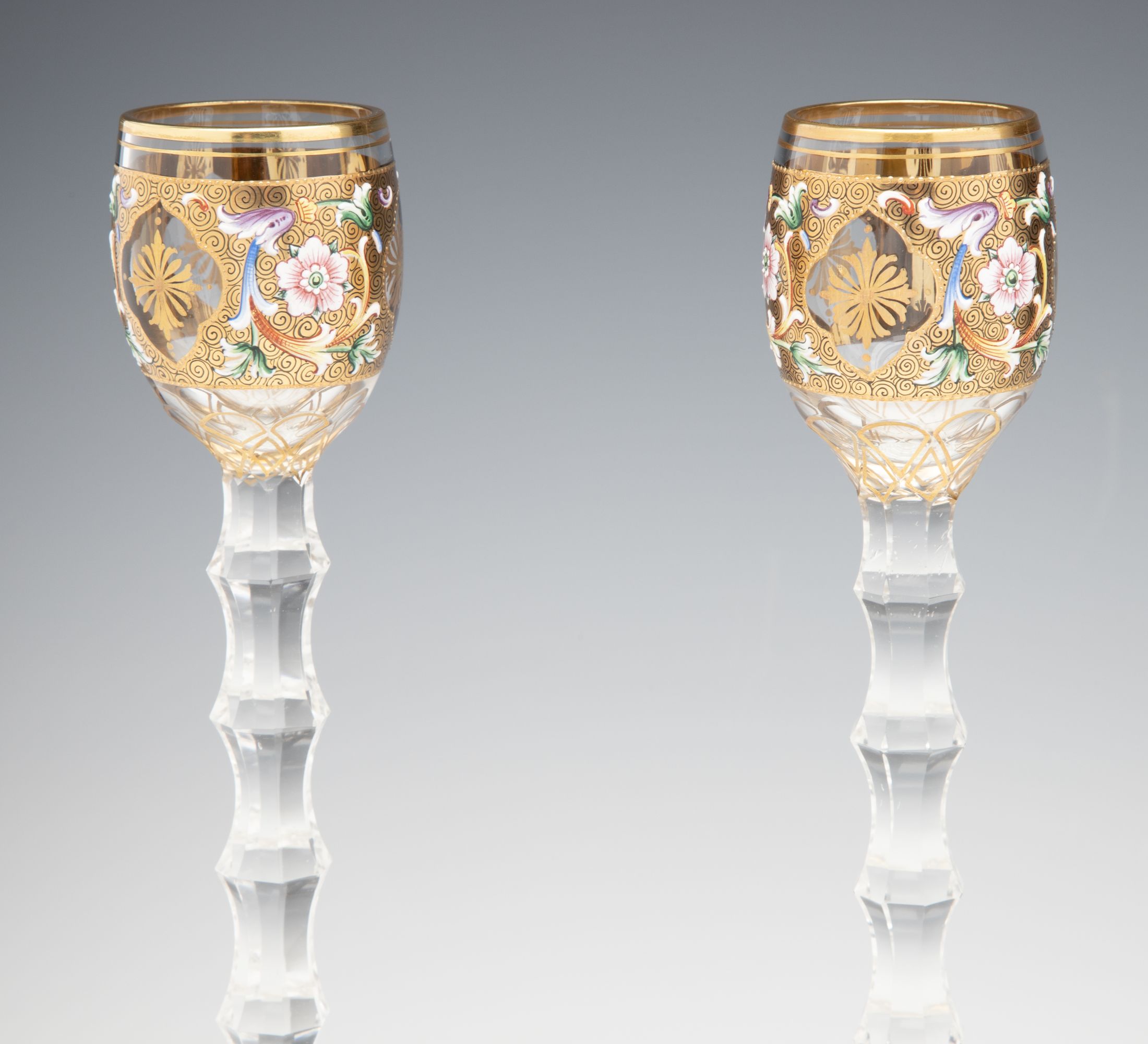 TWO MOSER GILT AND ENAMEL CORDIALS ON TALL CUT STEMS