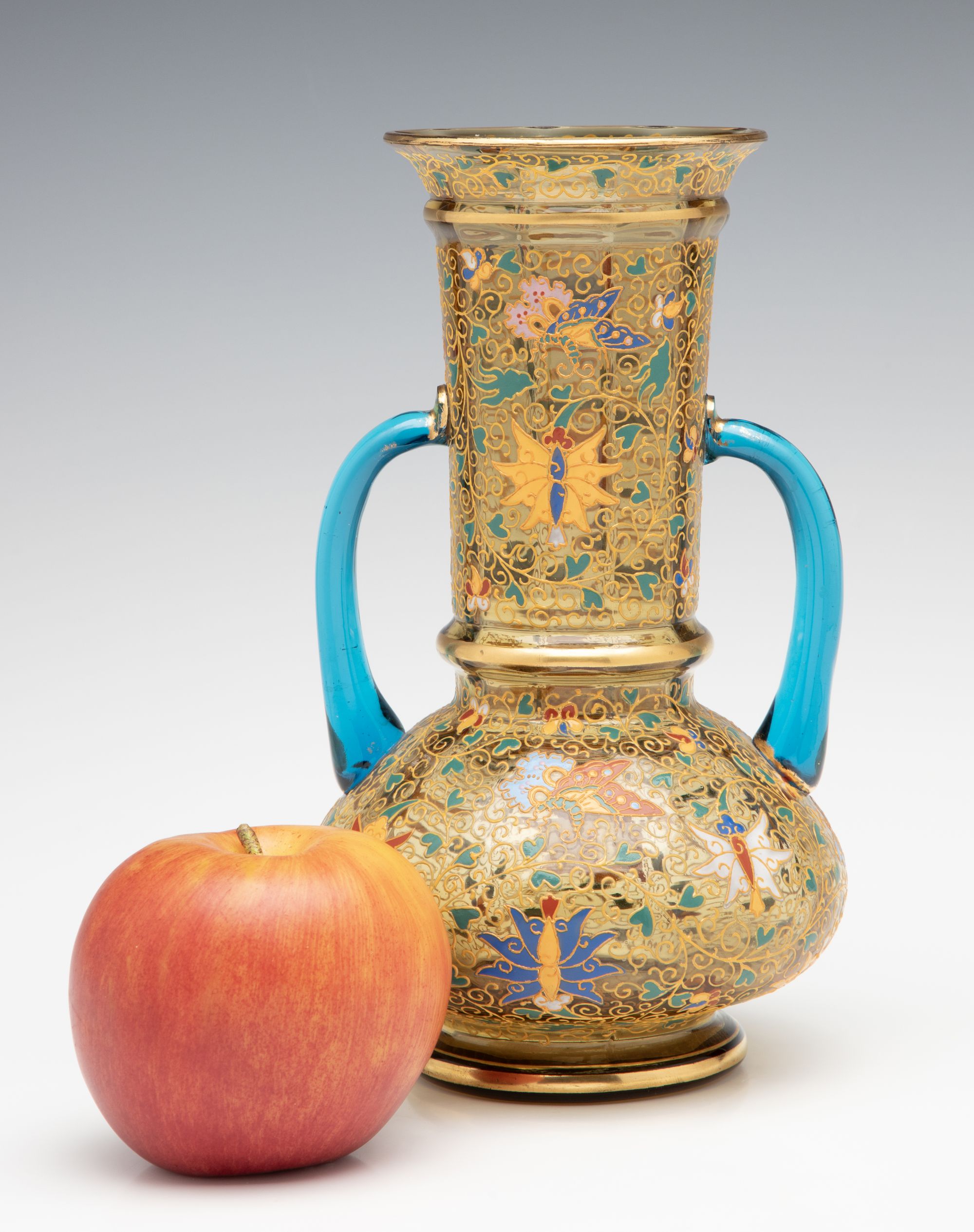 A MOSER GILT AND ENAMELED URN WITH APPLIED BLUE HANDLES