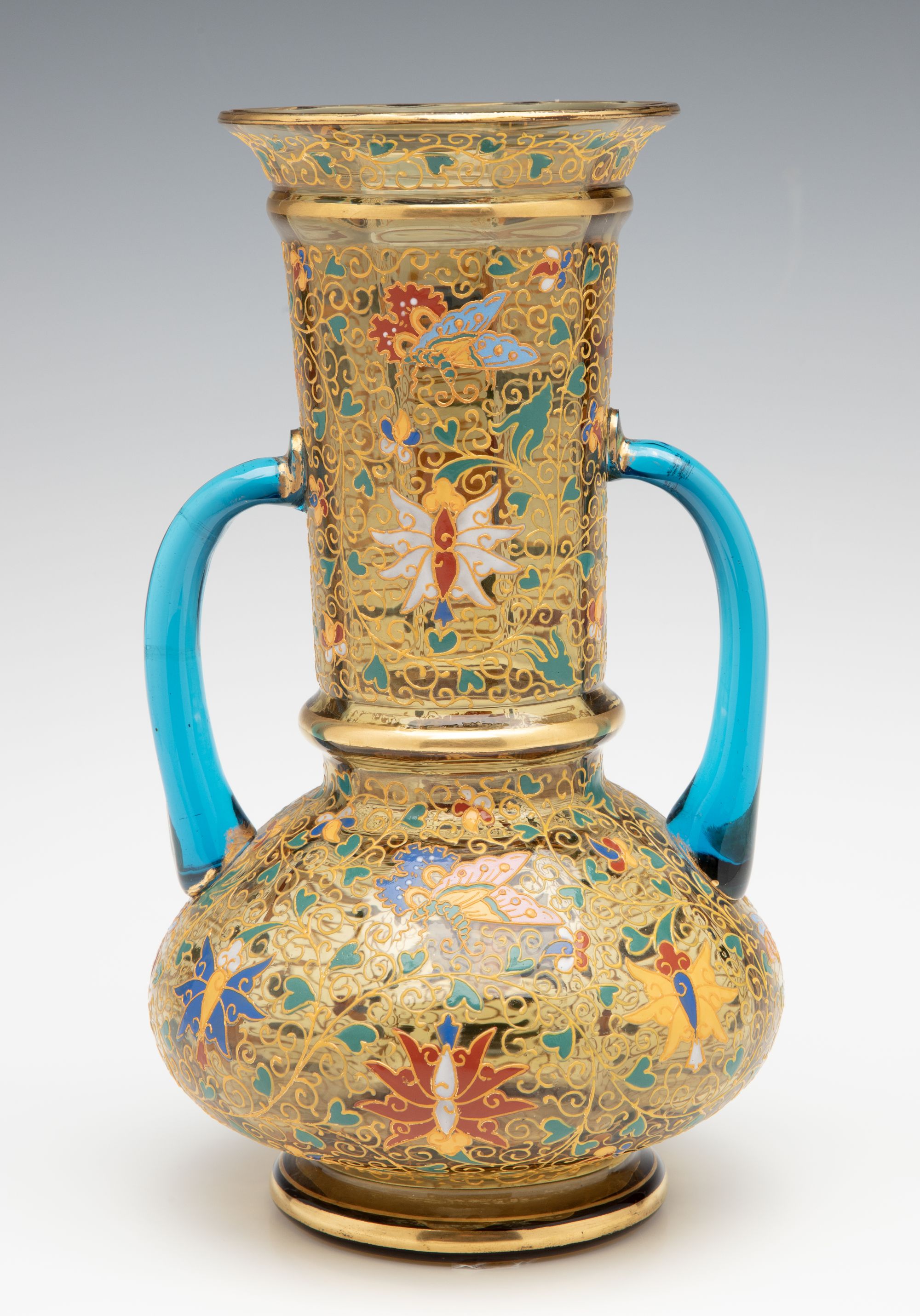 A MOSER GILT AND ENAMELED URN WITH APPLIED BLUE HANDLES