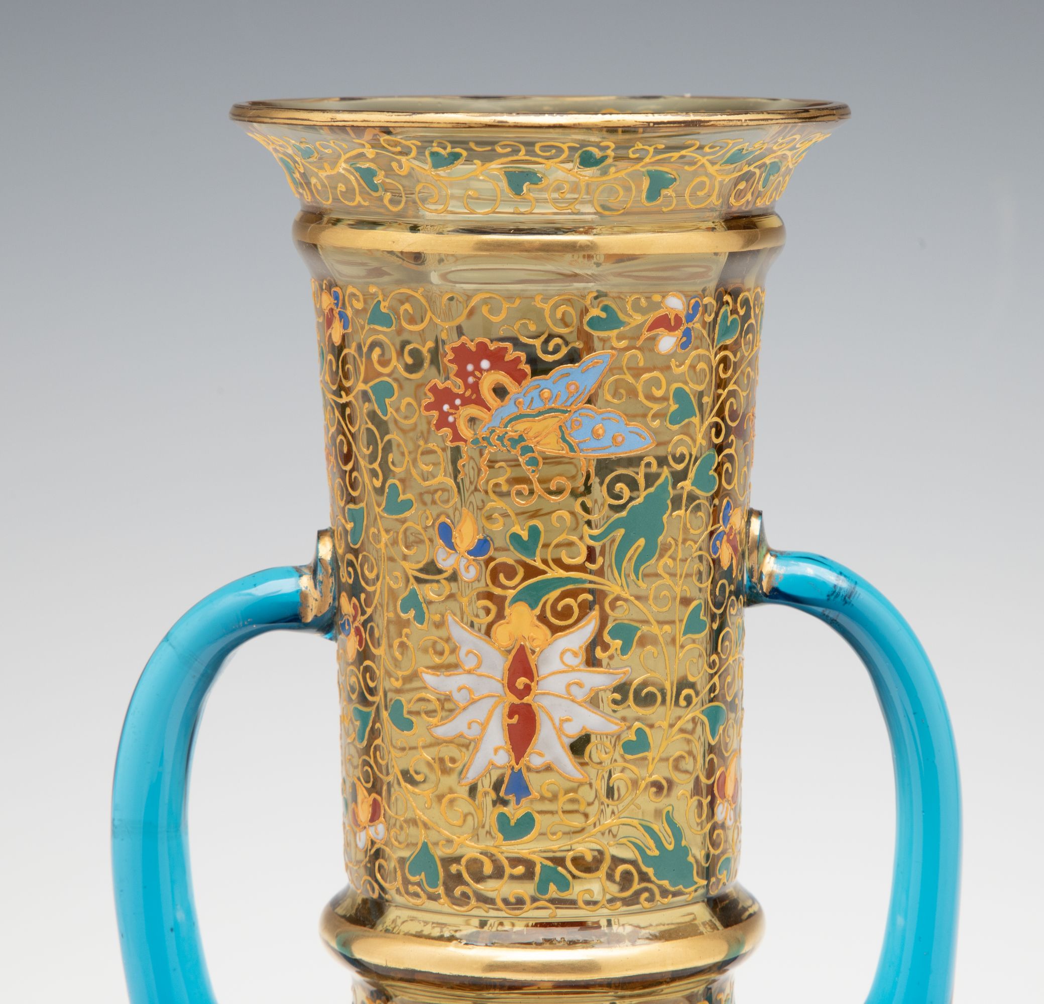 A MOSER GILT AND ENAMELED URN WITH APPLIED BLUE HANDLES