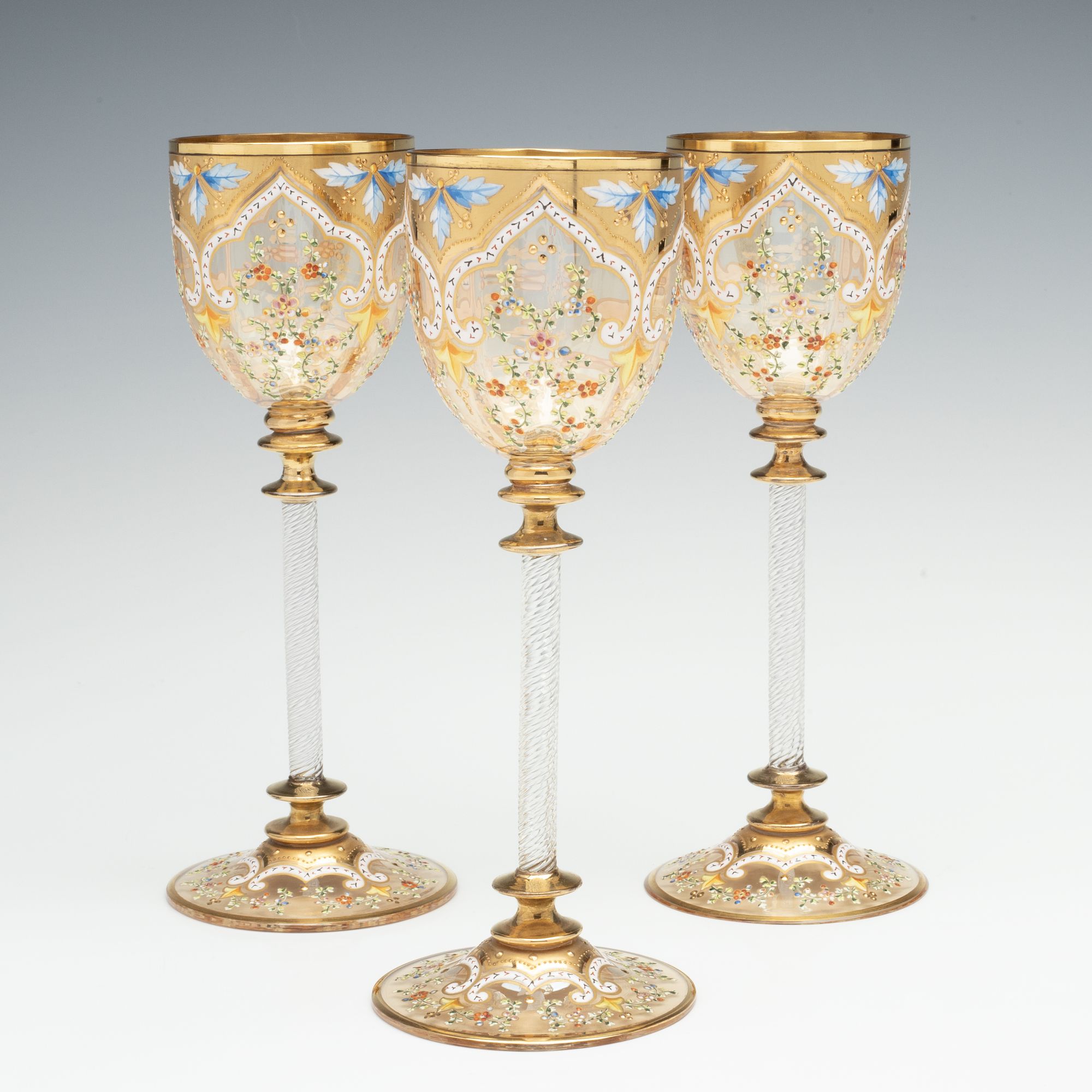 MOSER GILT AND ENAMEL WINES WITH FINE ROPE TWIST STEMS