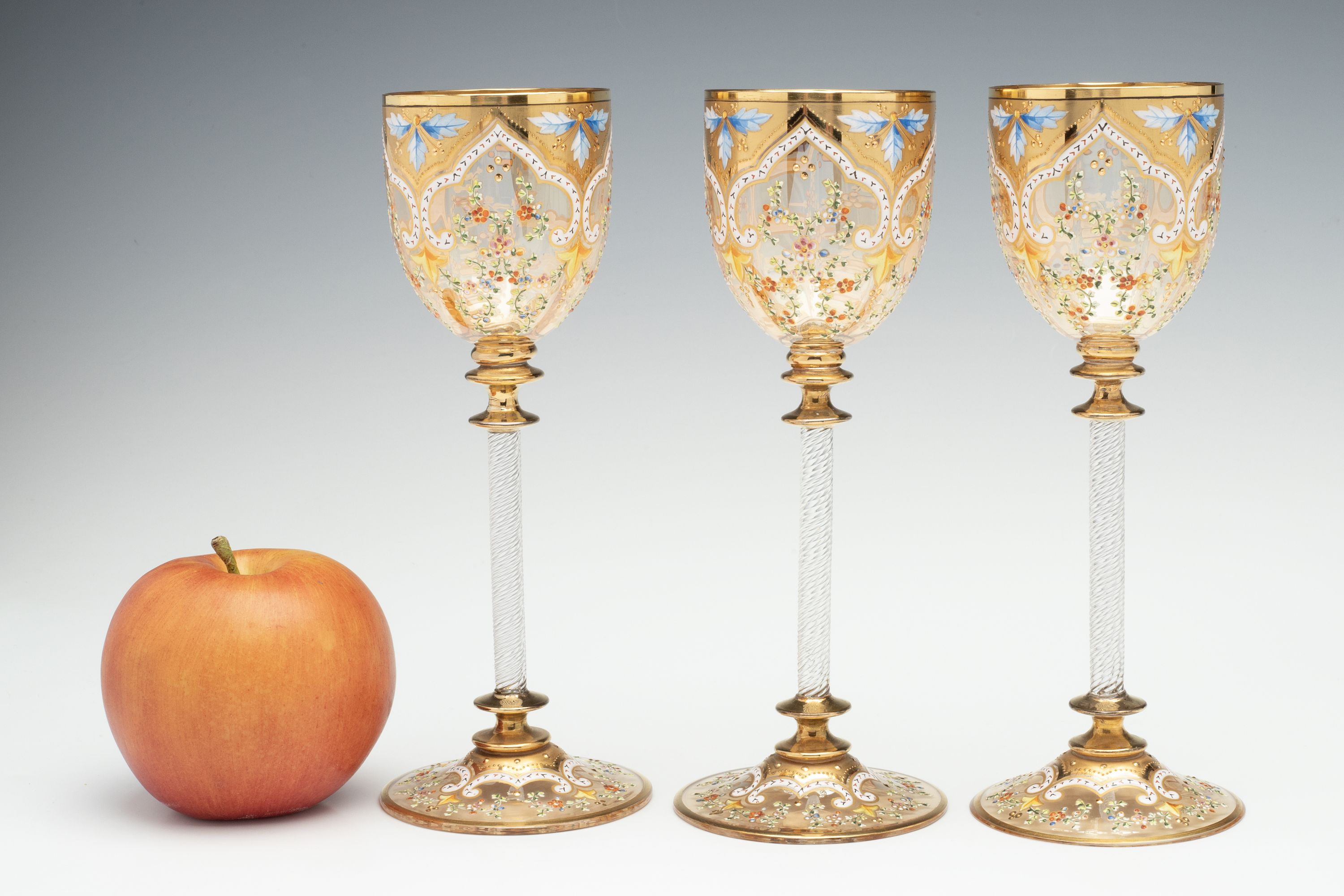 MOSER GILT AND ENAMEL WINES WITH FINE ROPE TWIST STEMS