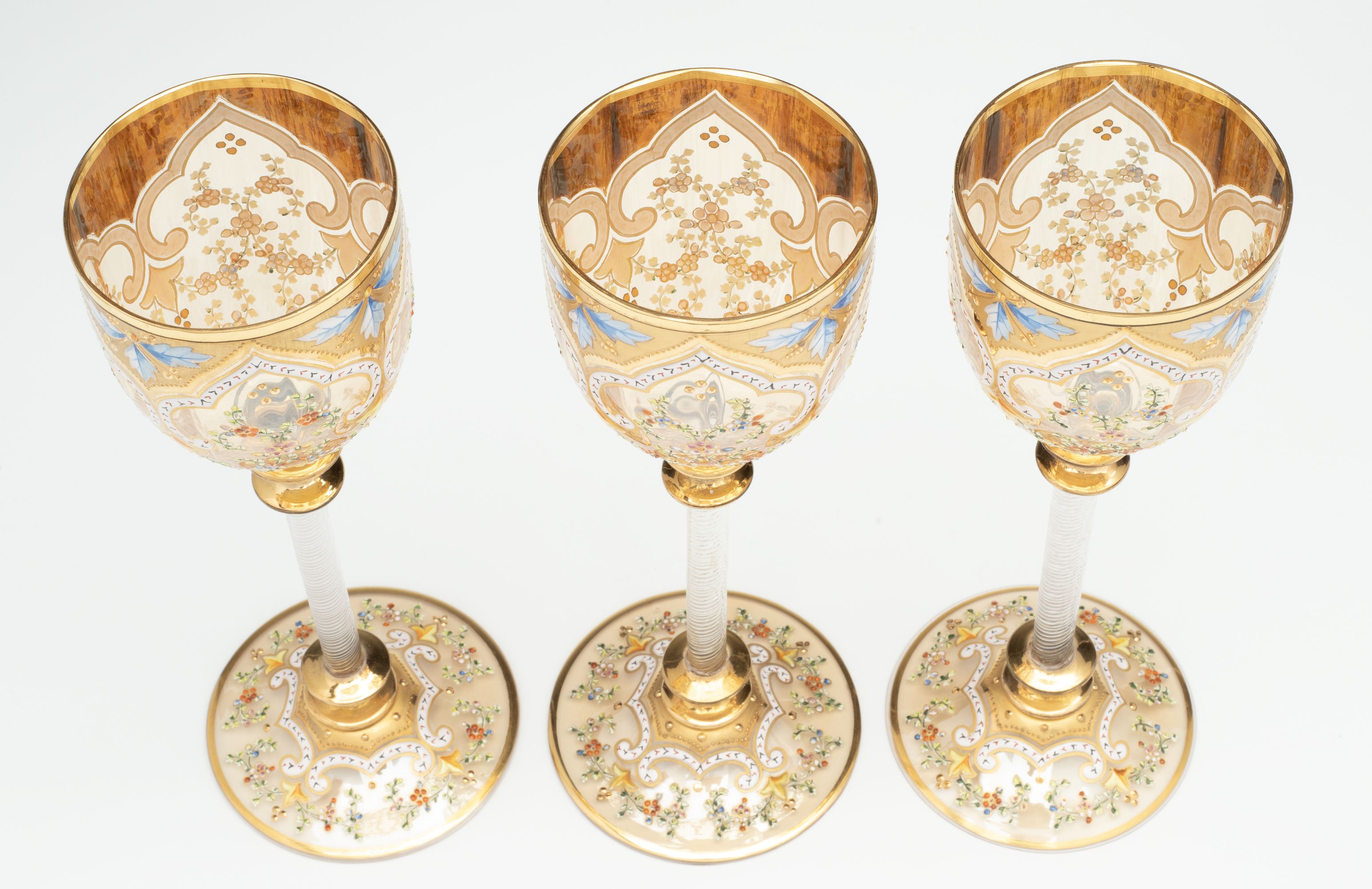 MOSER GILT AND ENAMEL WINES WITH FINE ROPE TWIST STEMS