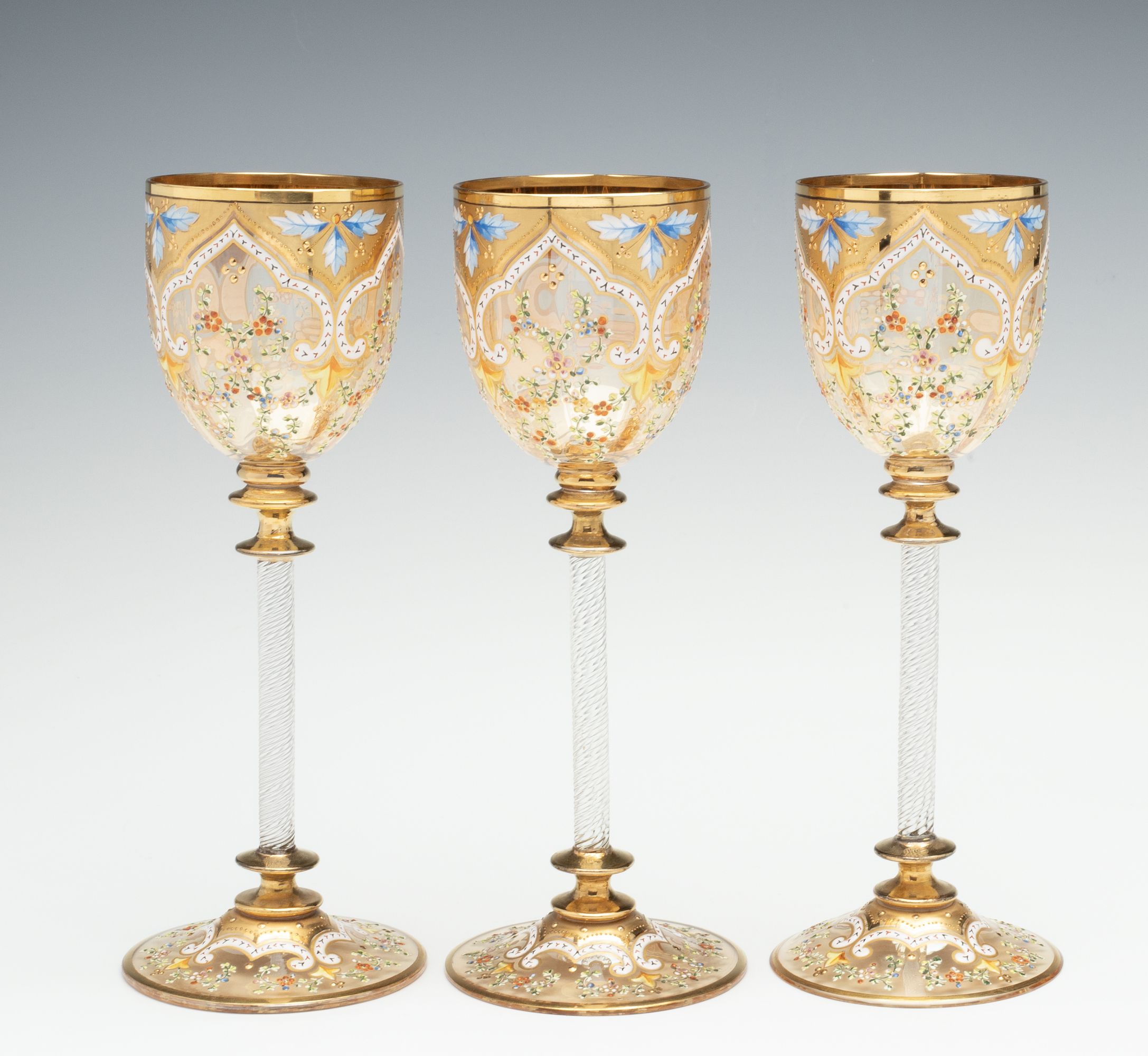 MOSER GILT AND ENAMEL WINES WITH FINE ROPE TWIST STEMS