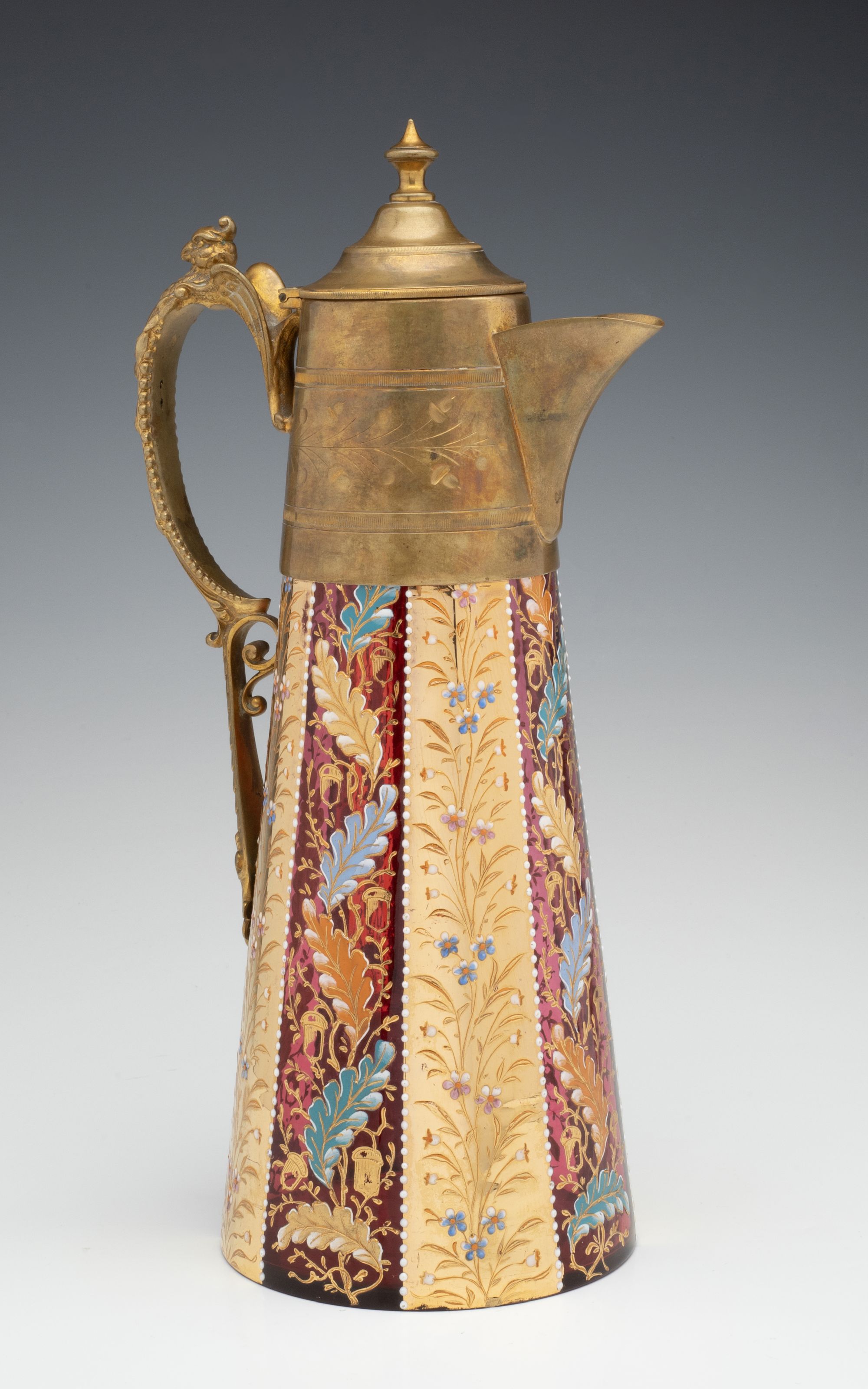 A MOSER GILT AND ENAMEL JUG WITH BRASS MOUNTS