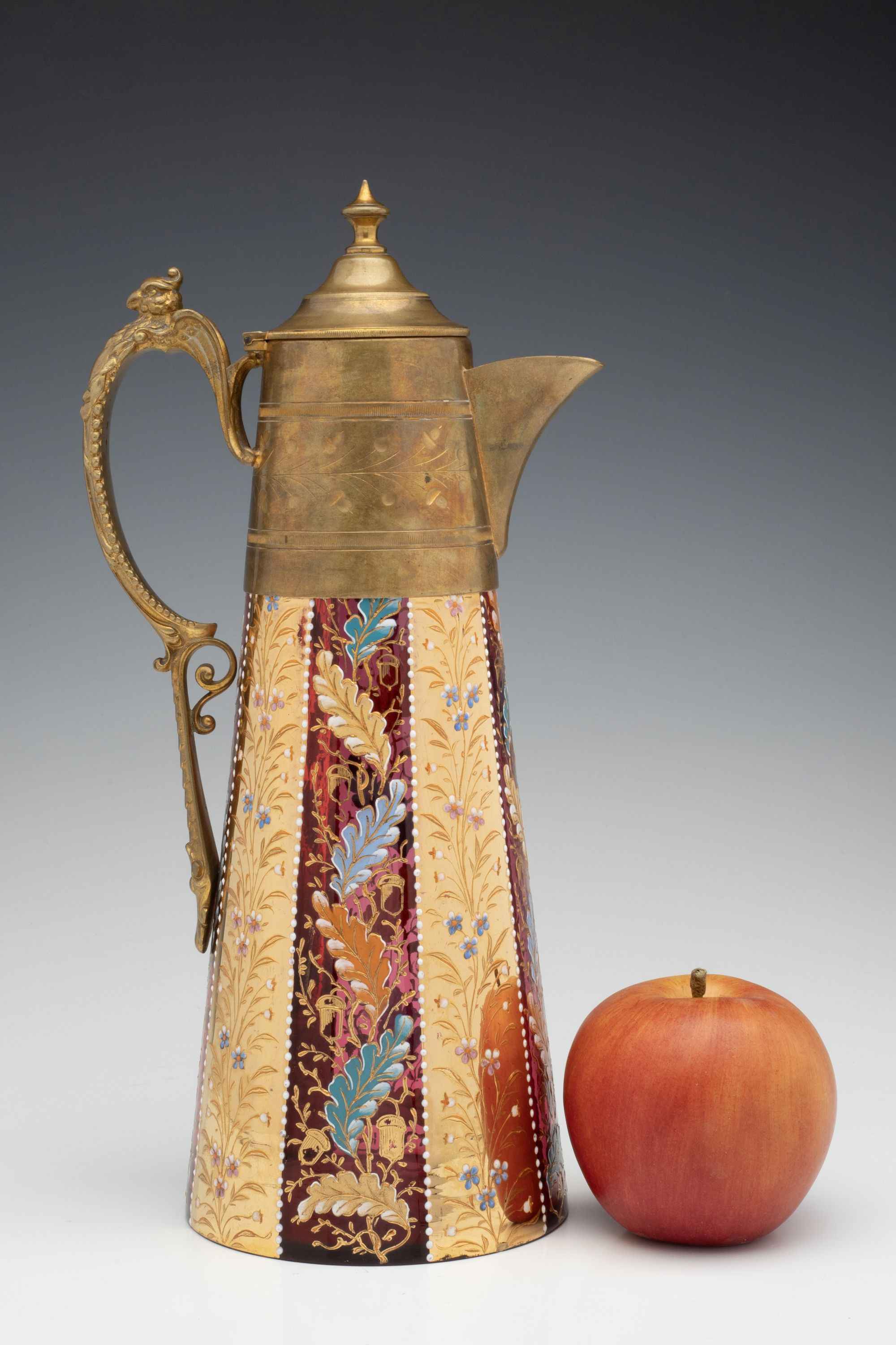 A MOSER GILT AND ENAMEL JUG WITH BRASS MOUNTS