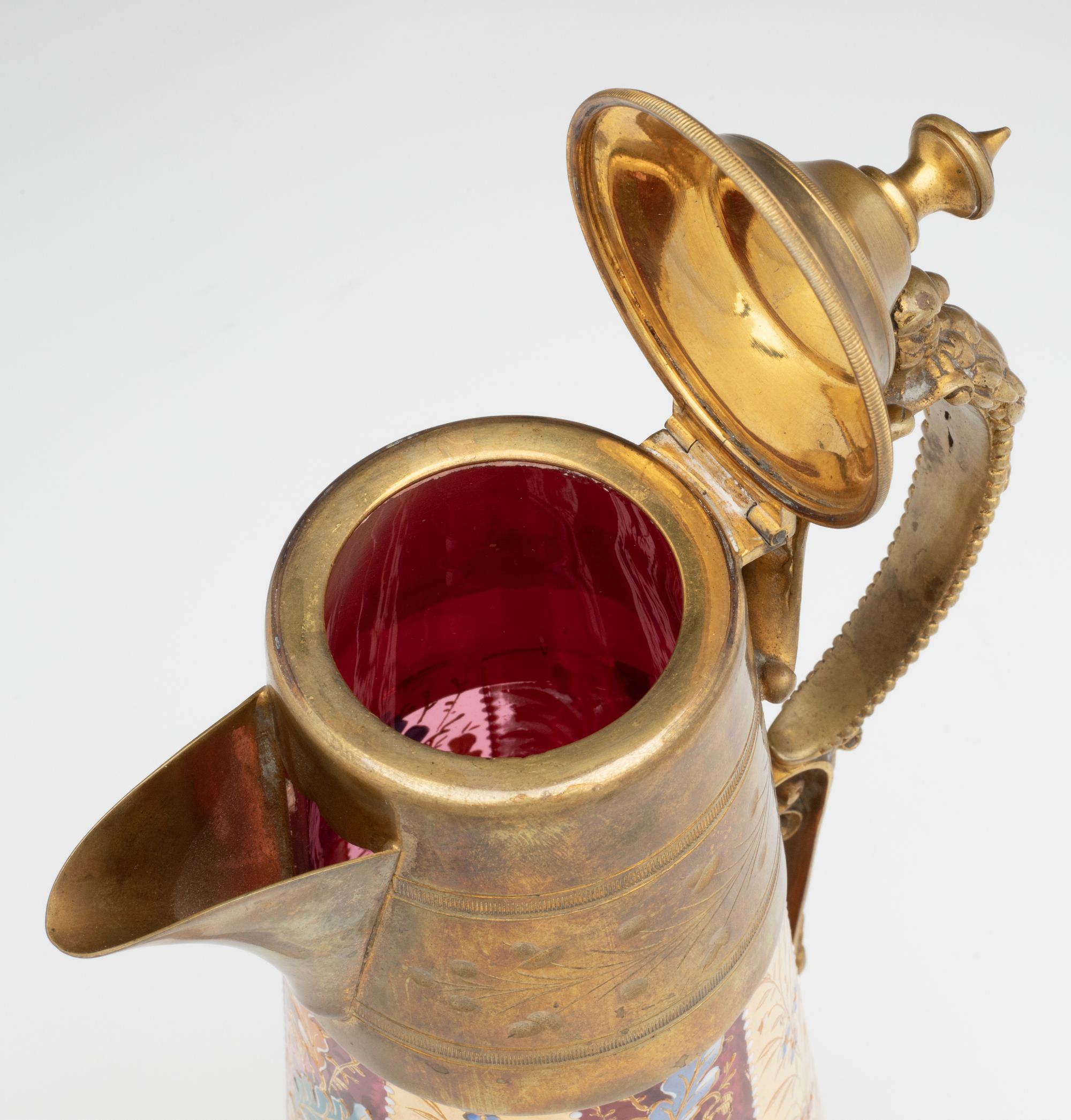 A MOSER GILT AND ENAMEL JUG WITH BRASS MOUNTS