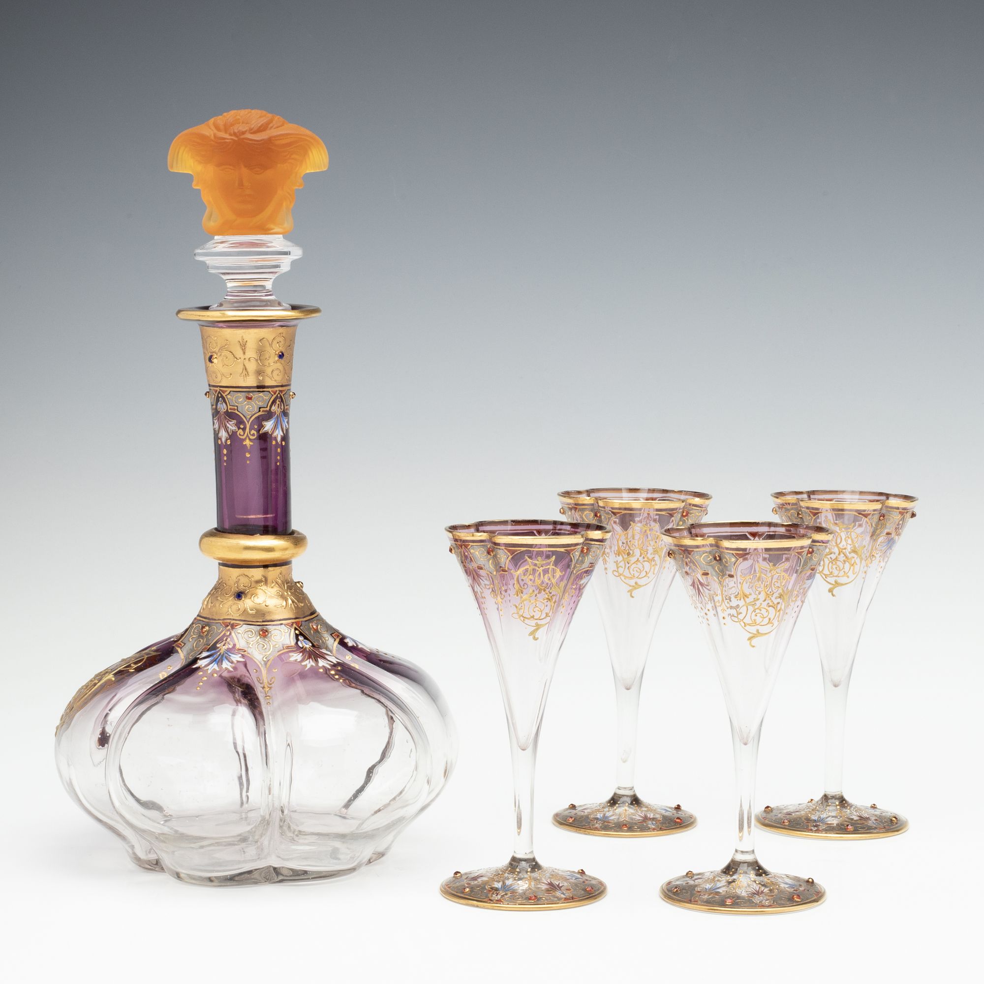 A JEWELED BOHEMIAN GLASS DECANTER AND FOUR STEMS