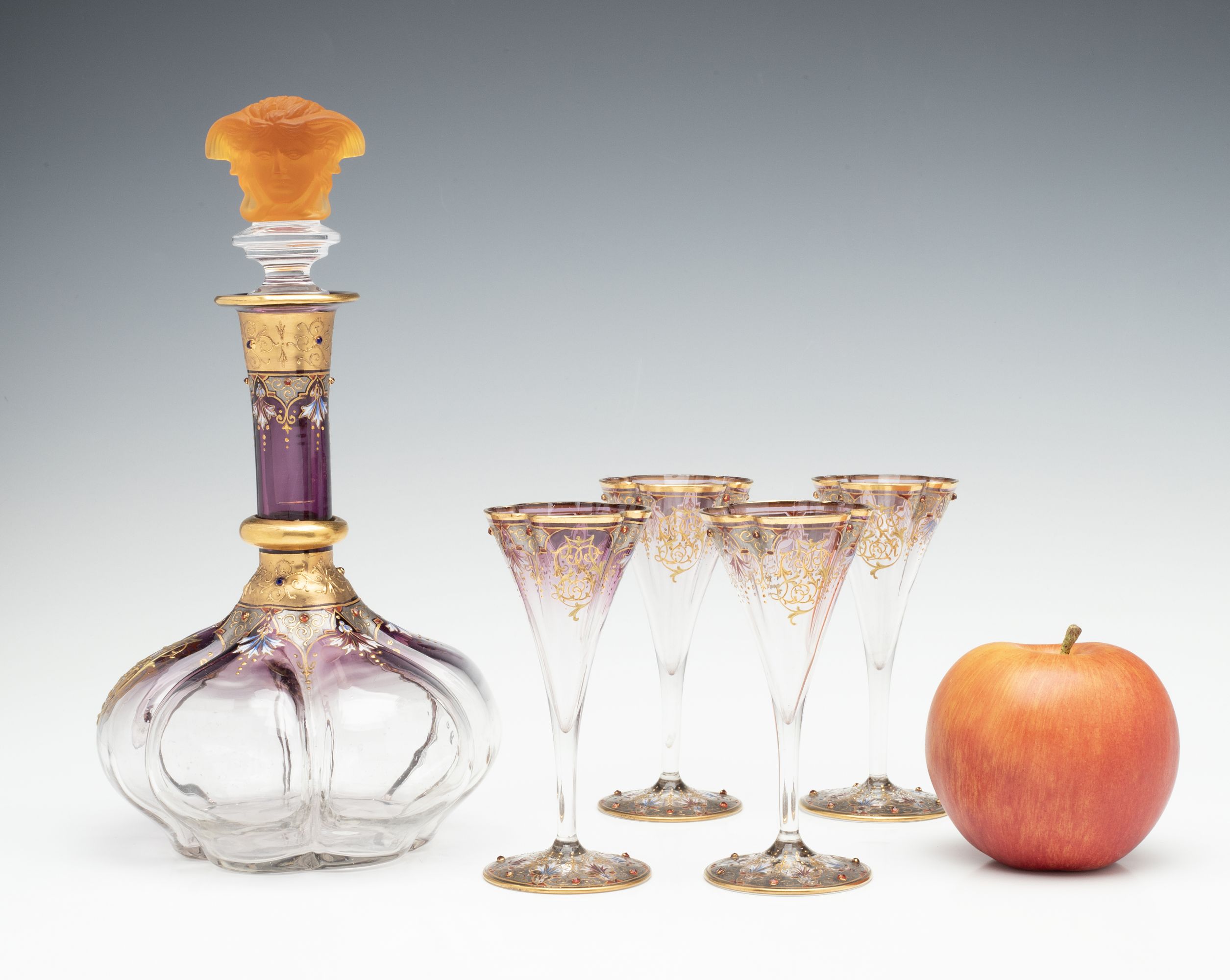 A JEWELED BOHEMIAN GLASS DECANTER AND FOUR STEMS