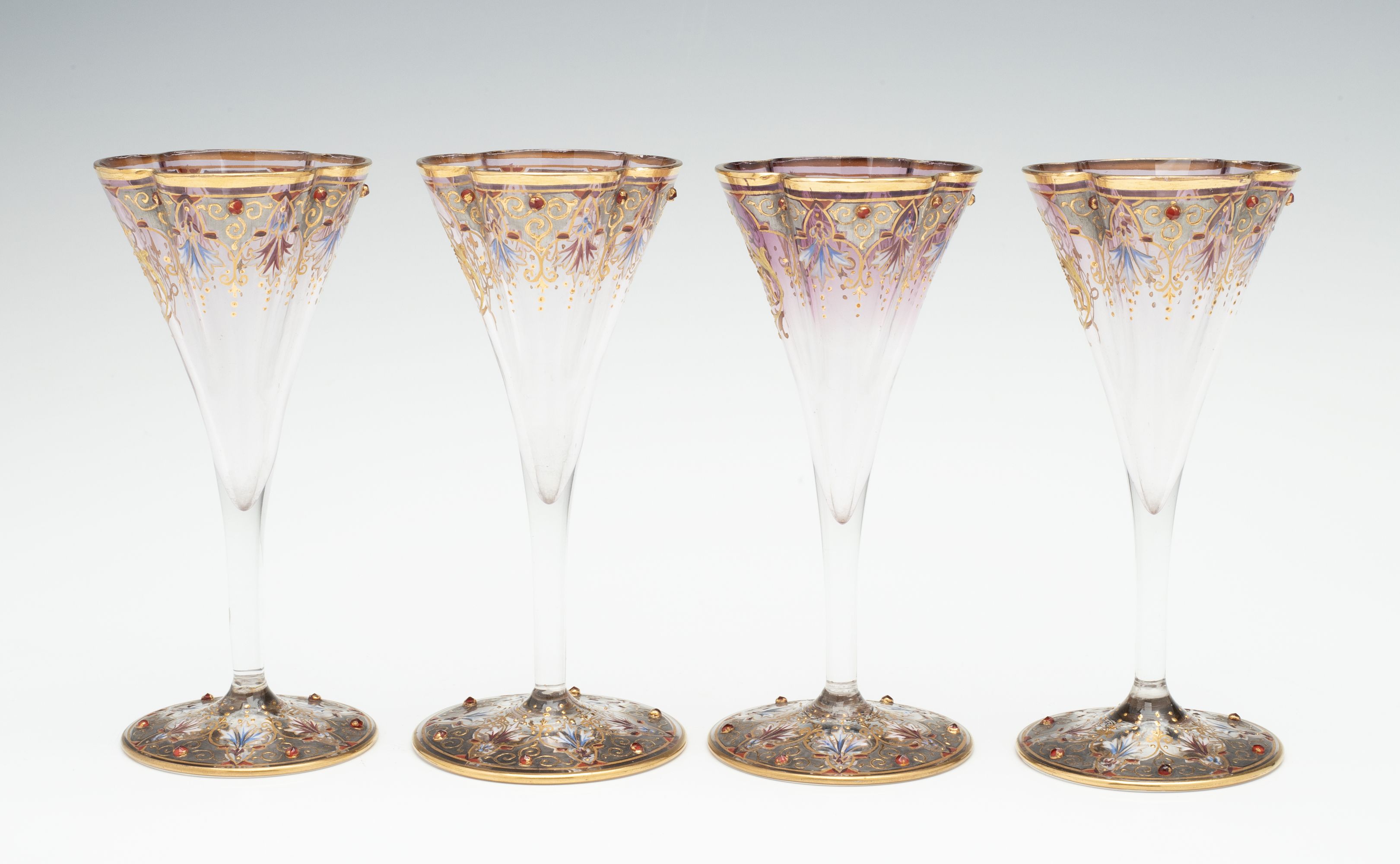 A JEWELED BOHEMIAN GLASS DECANTER AND FOUR STEMS