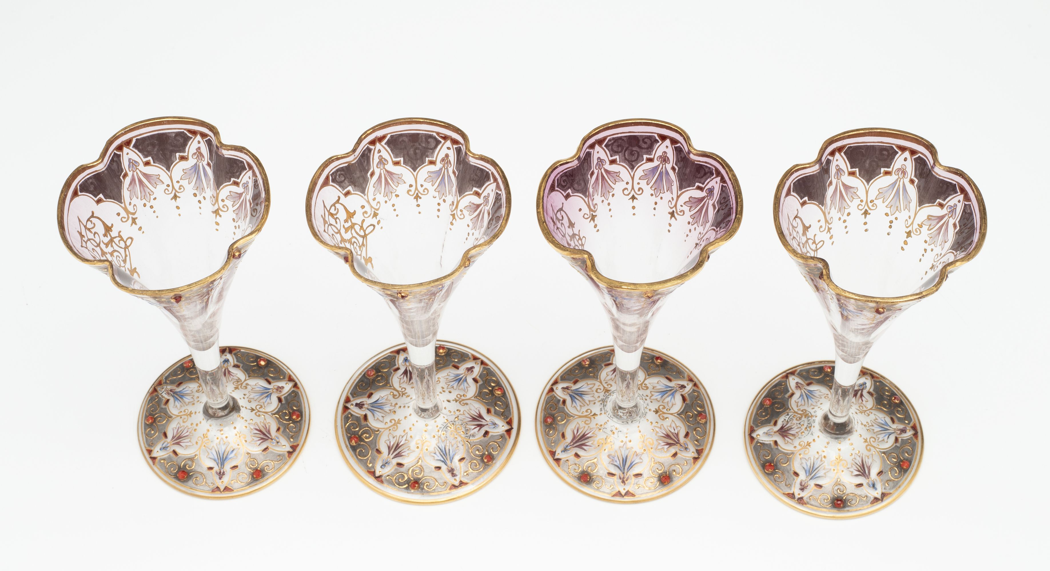 A JEWELED BOHEMIAN GLASS DECANTER AND FOUR STEMS