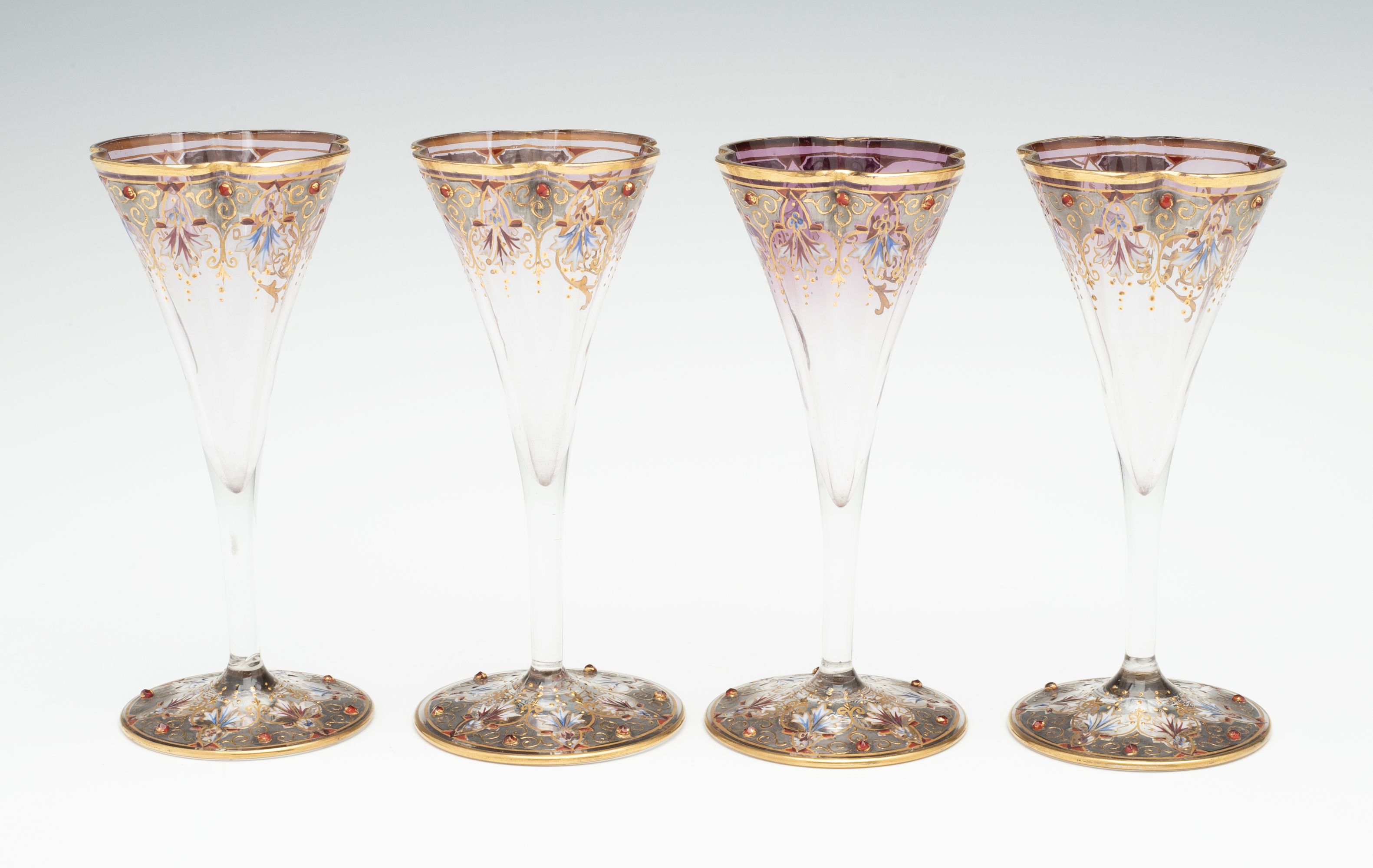 A JEWELED BOHEMIAN GLASS DECANTER AND FOUR STEMS