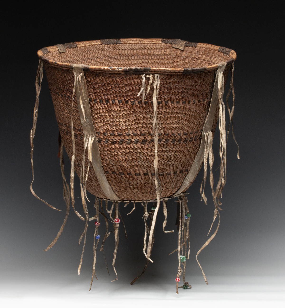 A GOOD 19TH CENT APACHE BURDEN BASKET WITH RAWHIDE