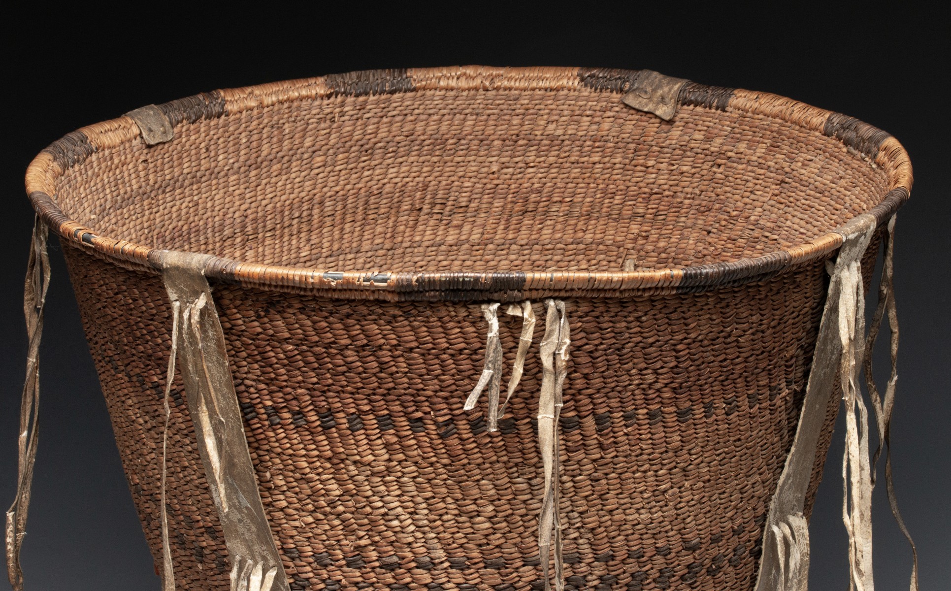 A GOOD 19TH CENT APACHE BURDEN BASKET WITH RAWHIDE