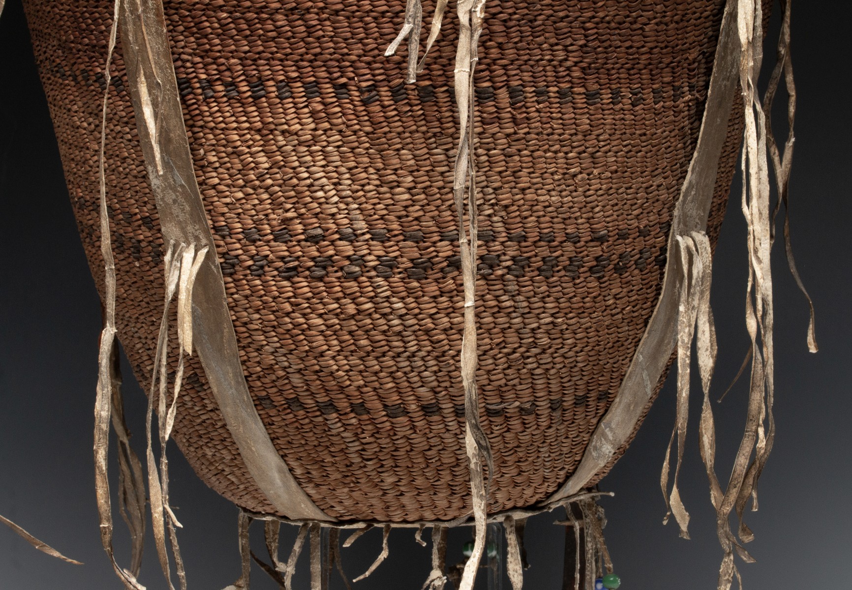 A GOOD 19TH CENT APACHE BURDEN BASKET WITH RAWHIDE