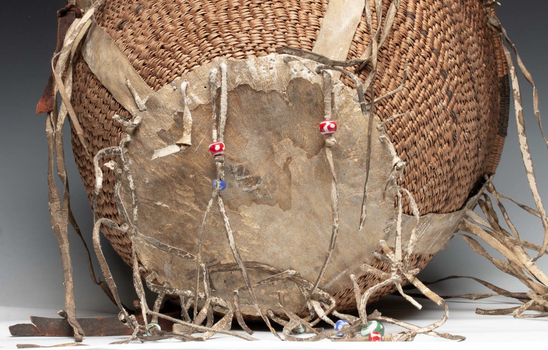 A GOOD 19TH CENT APACHE BURDEN BASKET WITH RAWHIDE