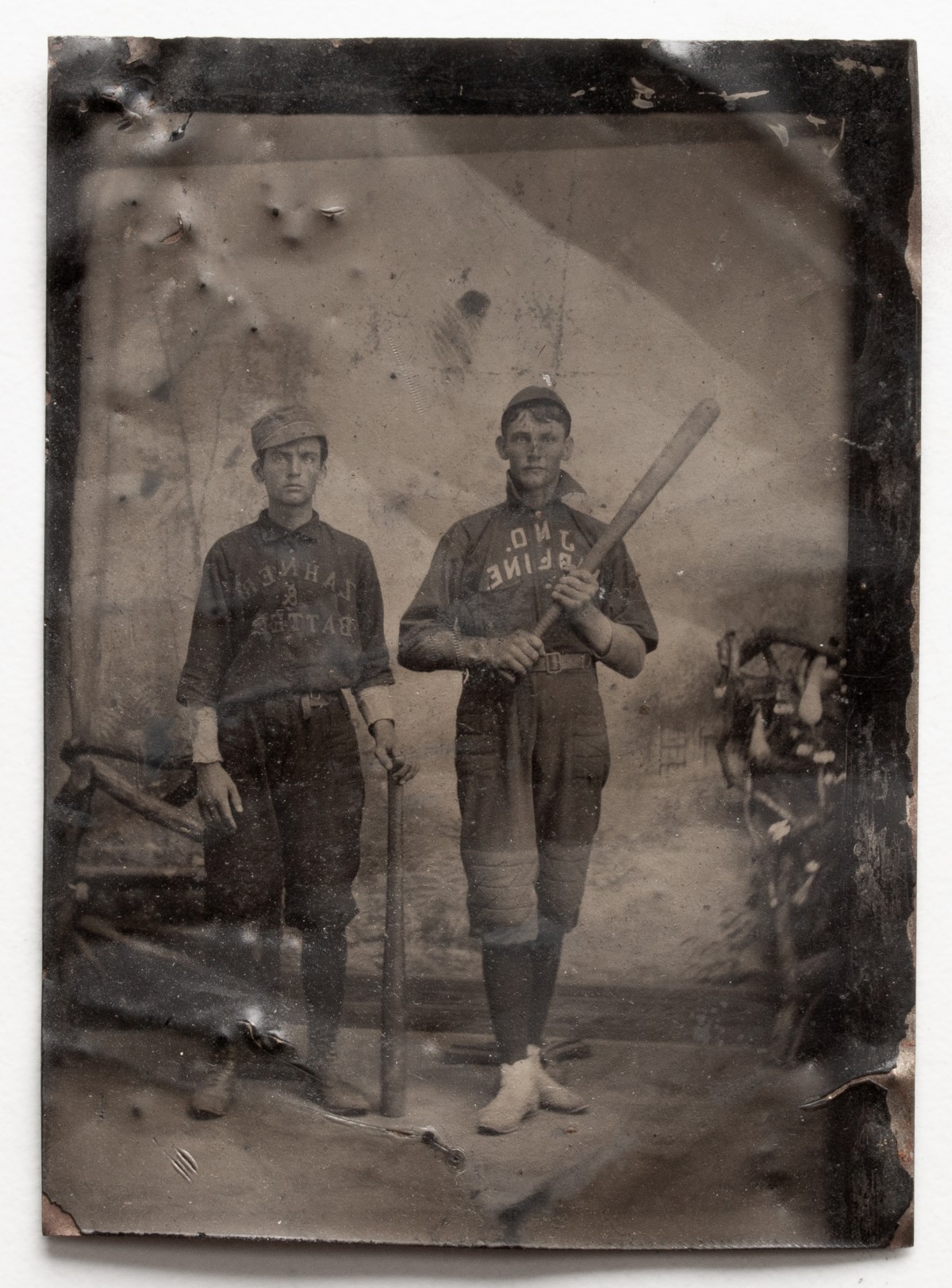 A QUARTER PLATE TINTYPE PORTRAIT OF BASEBALL PLAYERS