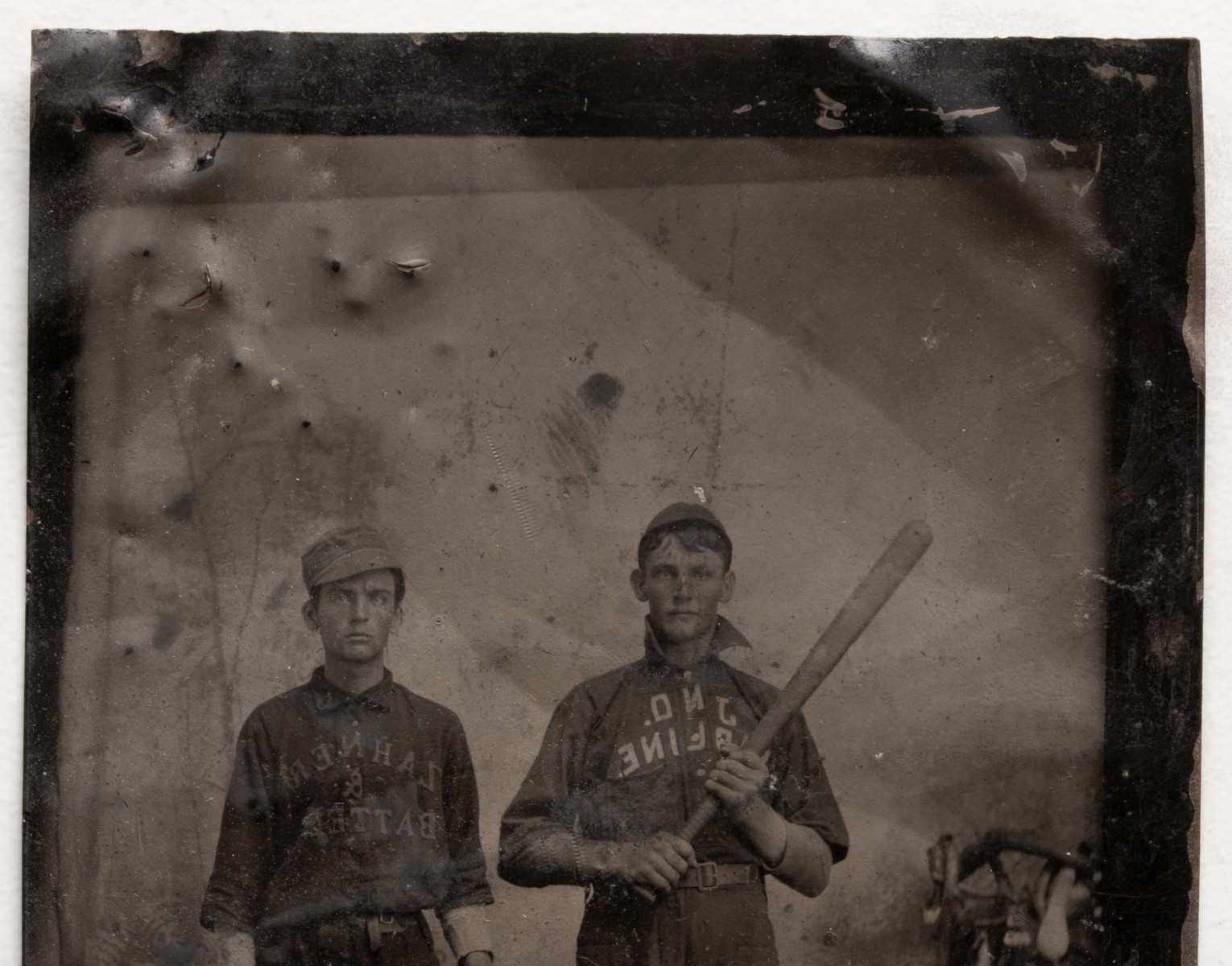 A QUARTER PLATE TINTYPE PORTRAIT OF BASEBALL PLAYERS