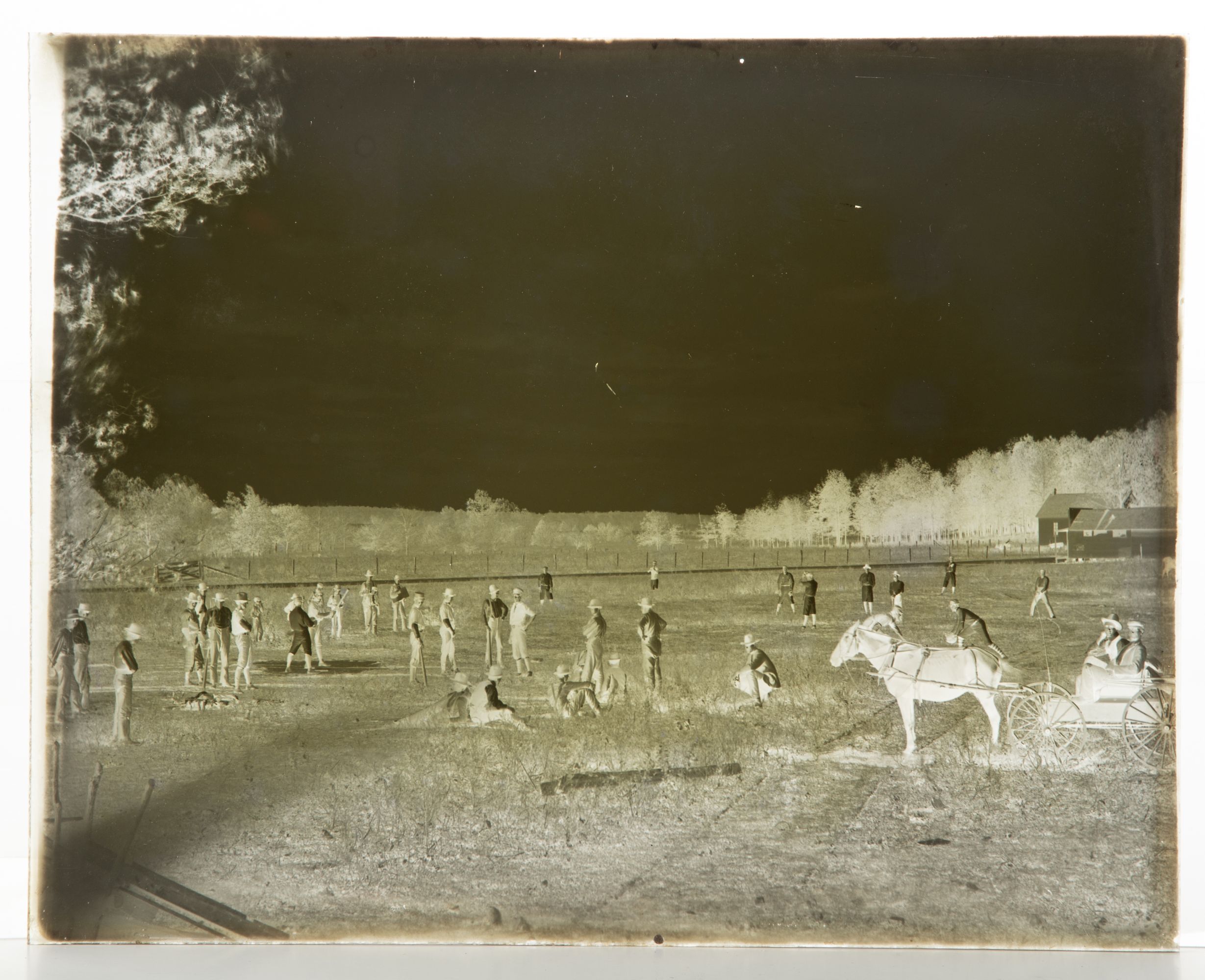 A 19C GLASS PLATE NEGATIVE PICTURING A BASEBALL GAME