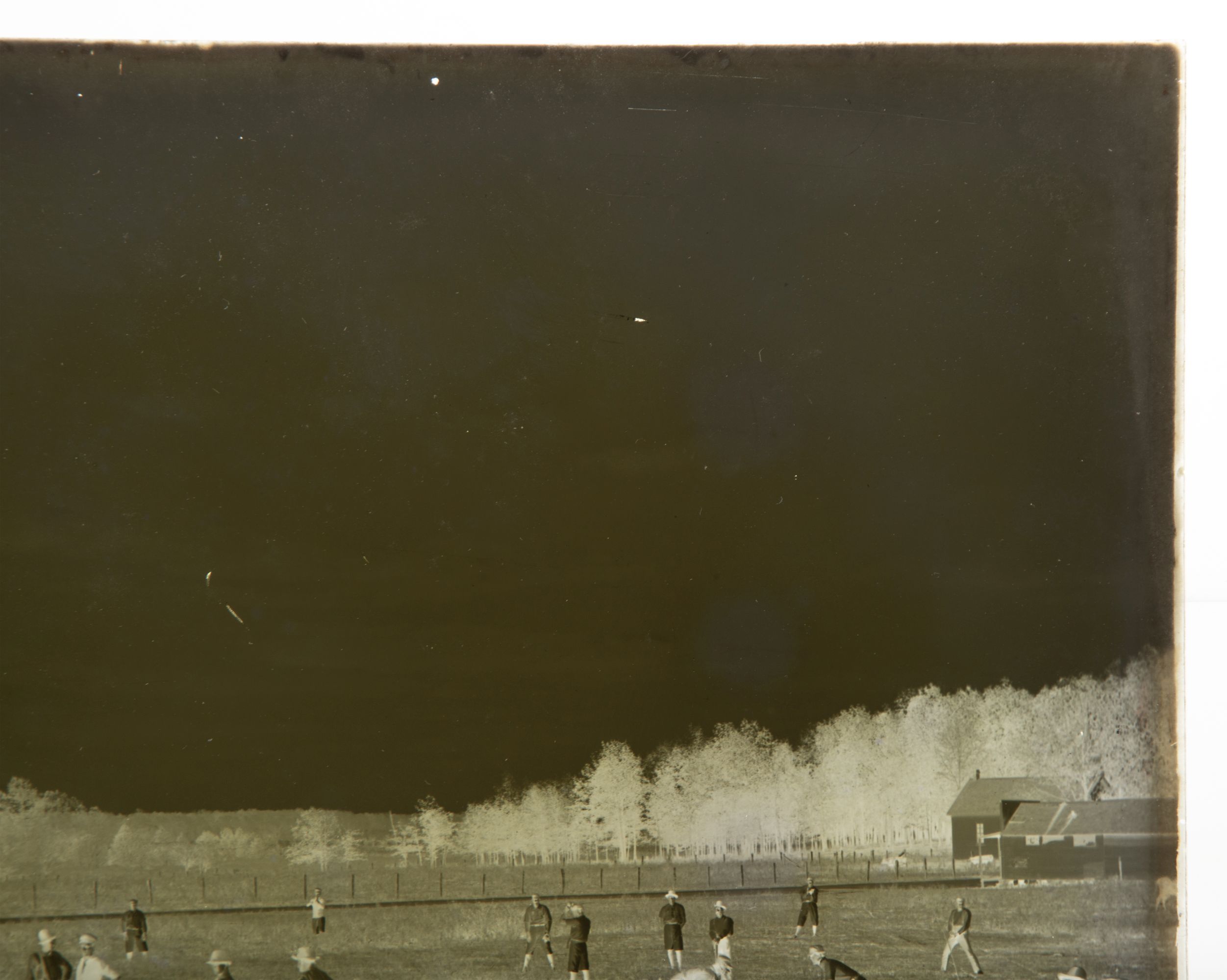 A 19C GLASS PLATE NEGATIVE PICTURING A BASEBALL GAME