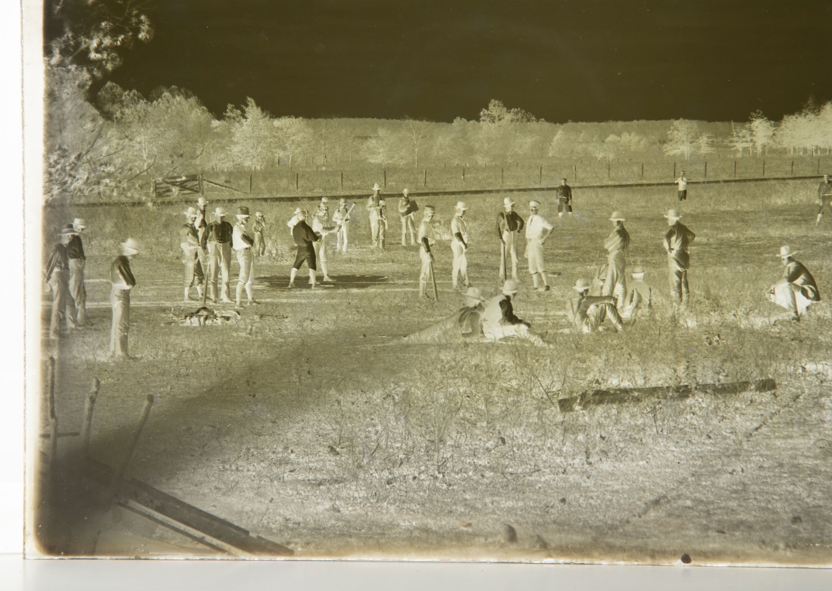 A 19C GLASS PLATE NEGATIVE PICTURING A BASEBALL GAME