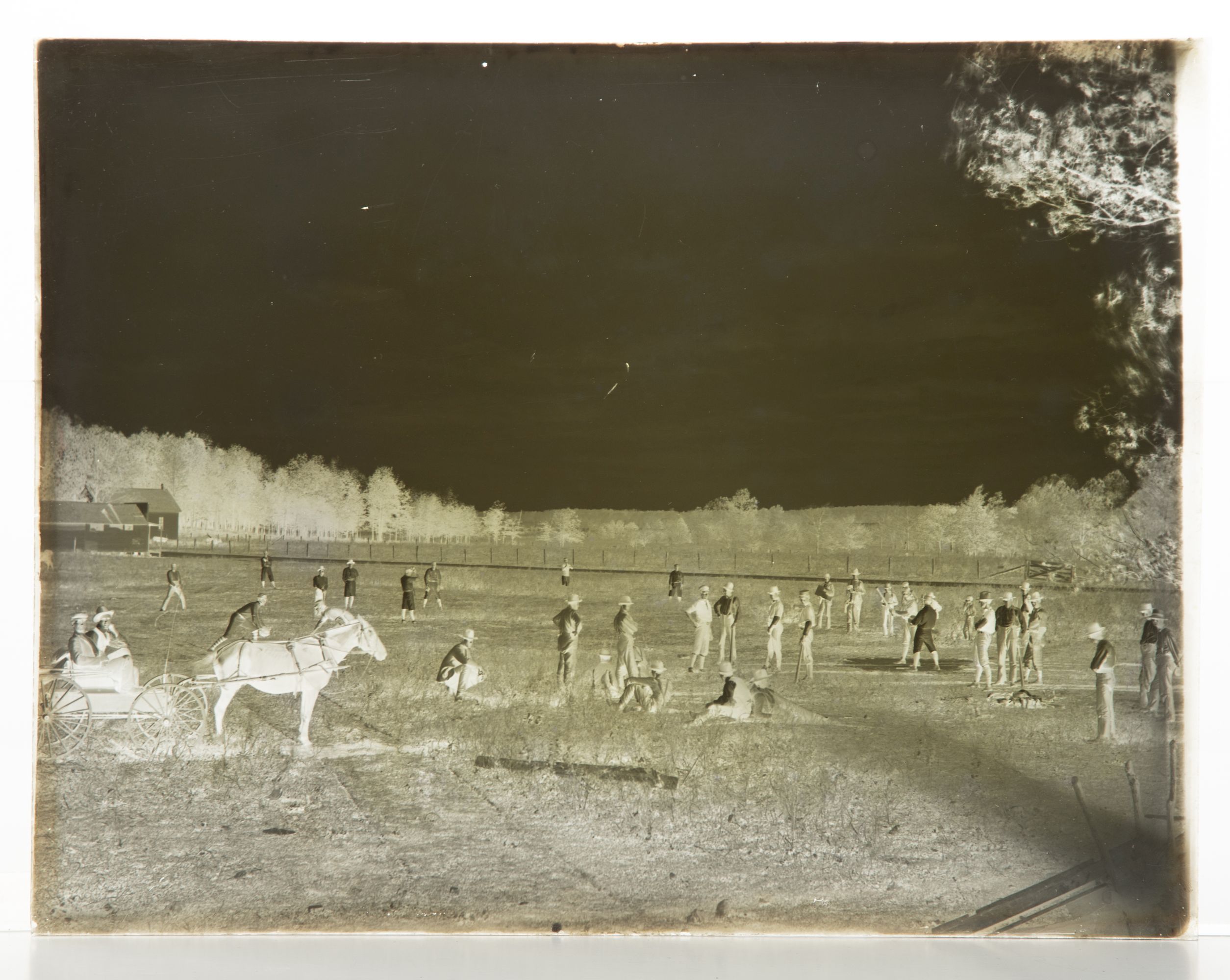 A 19C GLASS PLATE NEGATIVE PICTURING A BASEBALL GAME