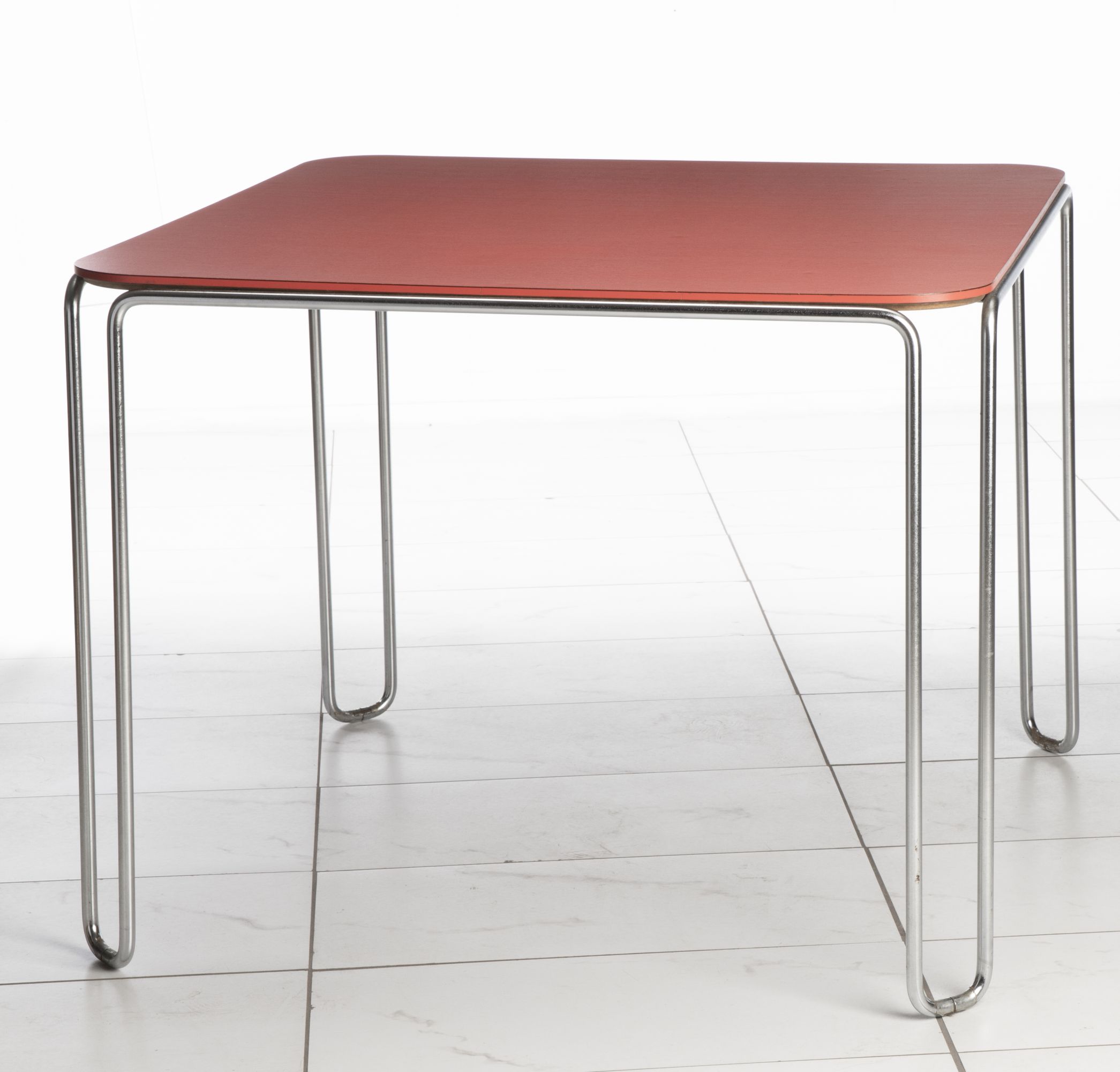 A SCARCE MARCEL BREUER MODEL B10 TABLE WITH RED TOP