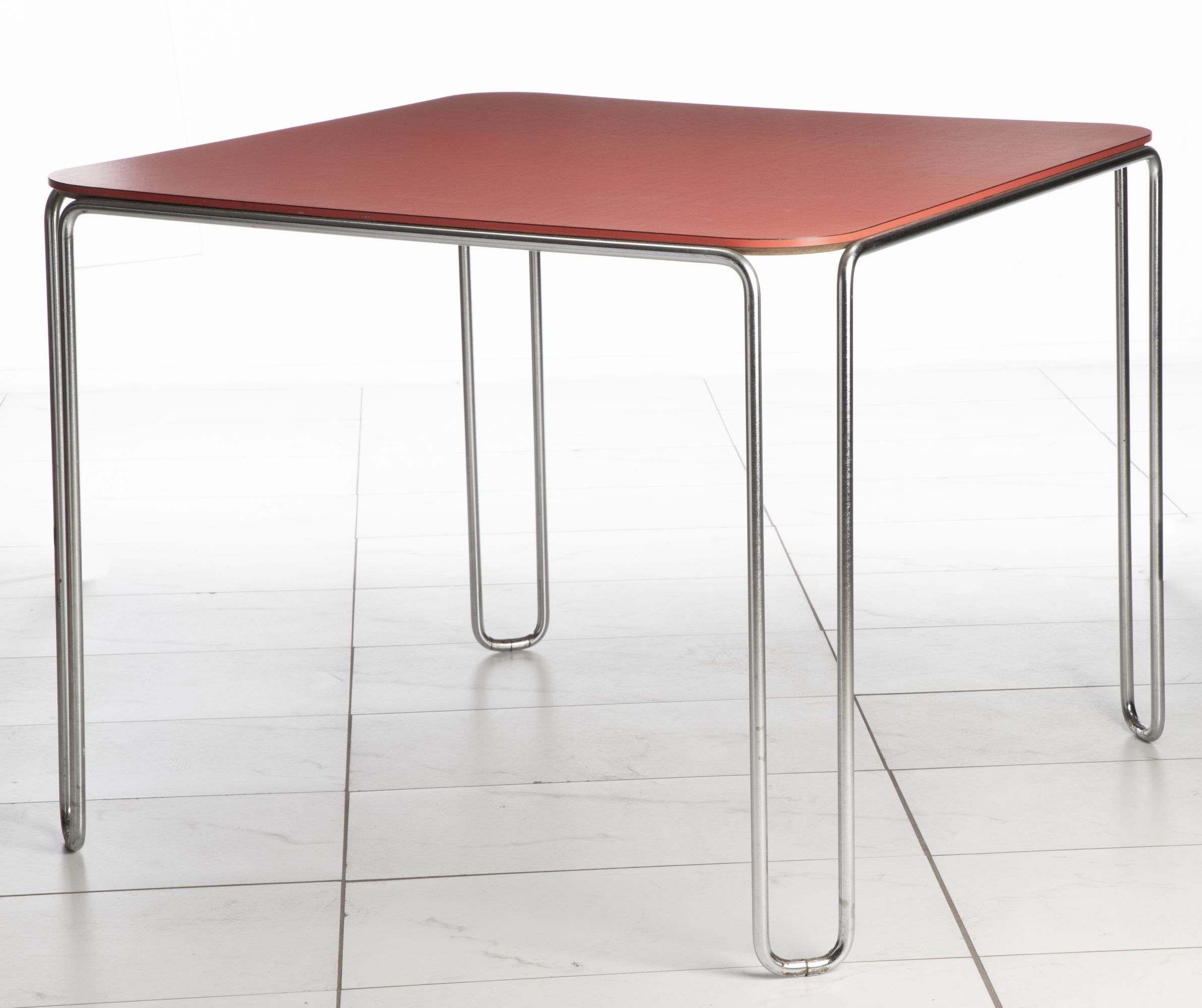 A SCARCE MARCEL BREUER MODEL B10 TABLE WITH RED TOP