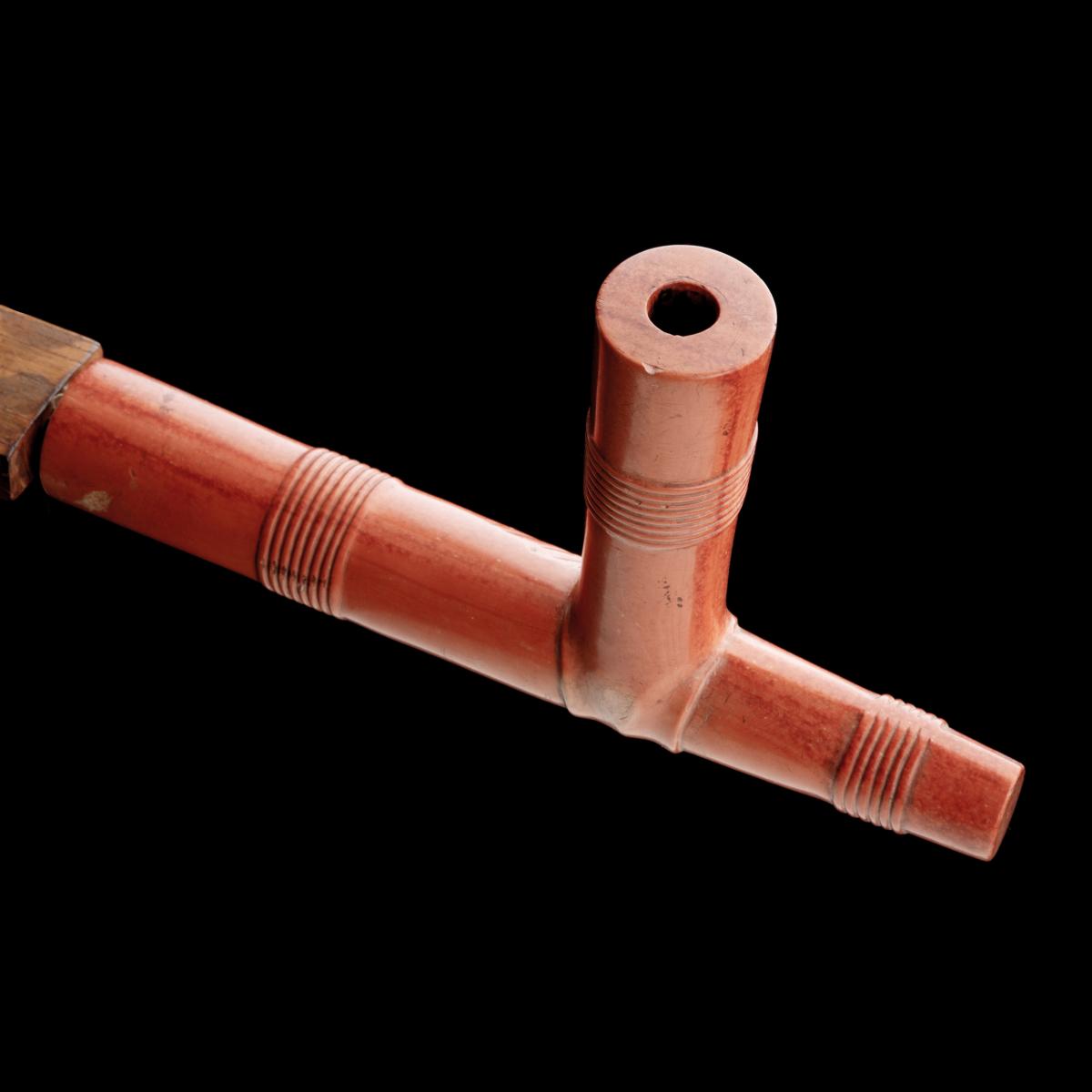 A LAKOTA PIPE WITH SALMON COLORED CATLINITE BOWL