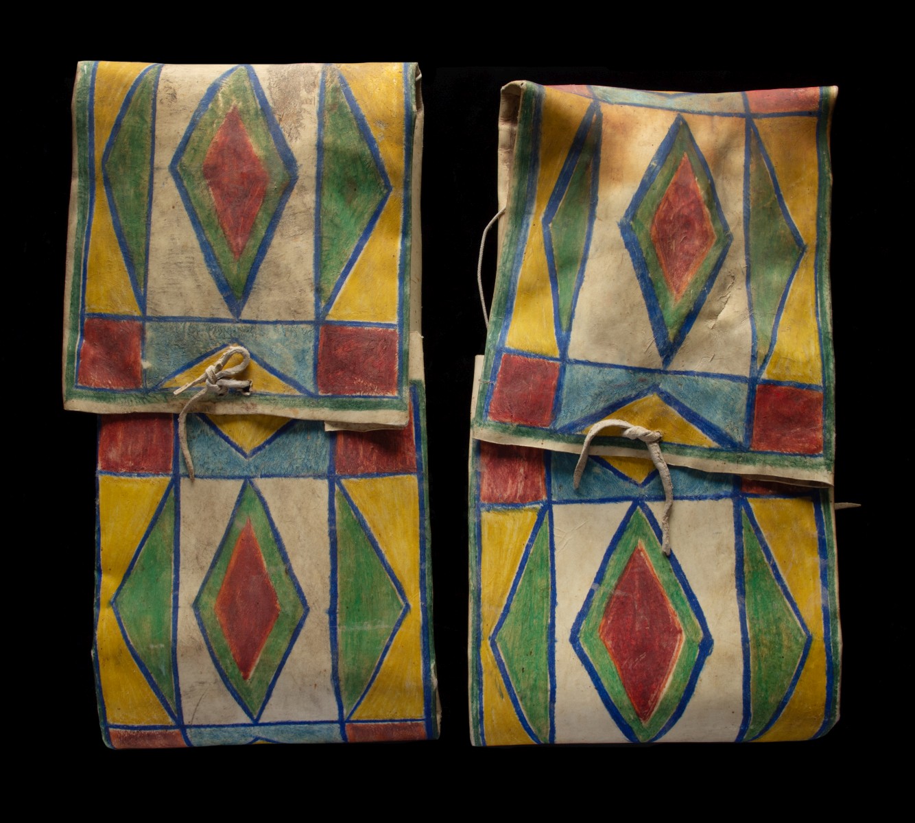 A MATCHED PAIR OF CROW PARFLECHE ENVELOPES CIRCA 1900