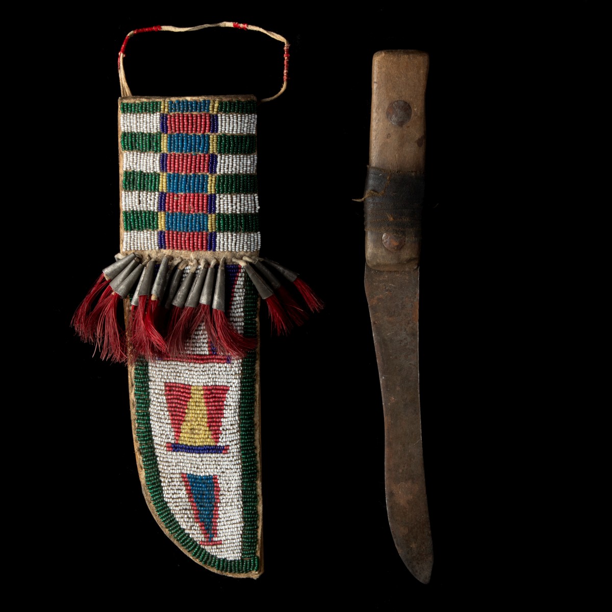 A FINE CHEYENNE BEADED KNIFE SHEATH WITH METAL CONES